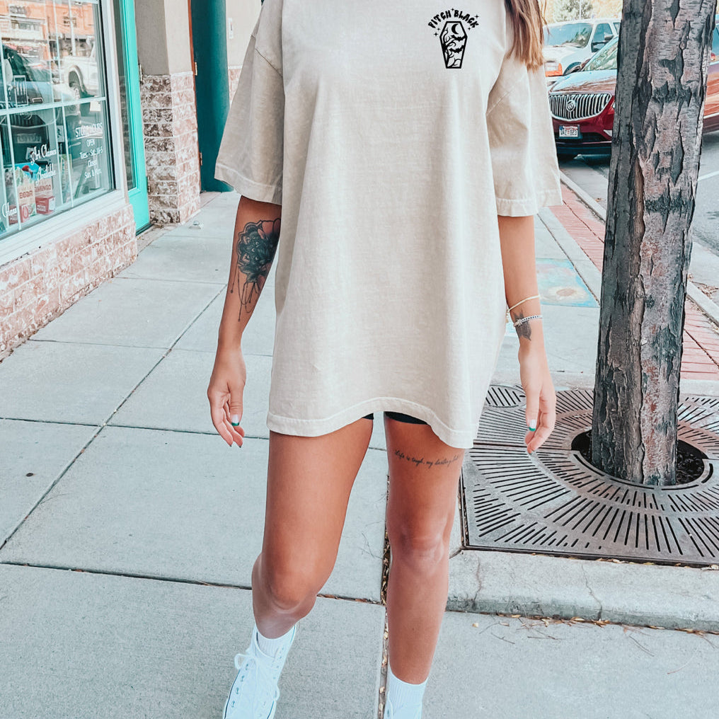 Black graphic t-shirt featuring a bold ray design from Shop Karma Tees, displayed flat with a focus on the front print.