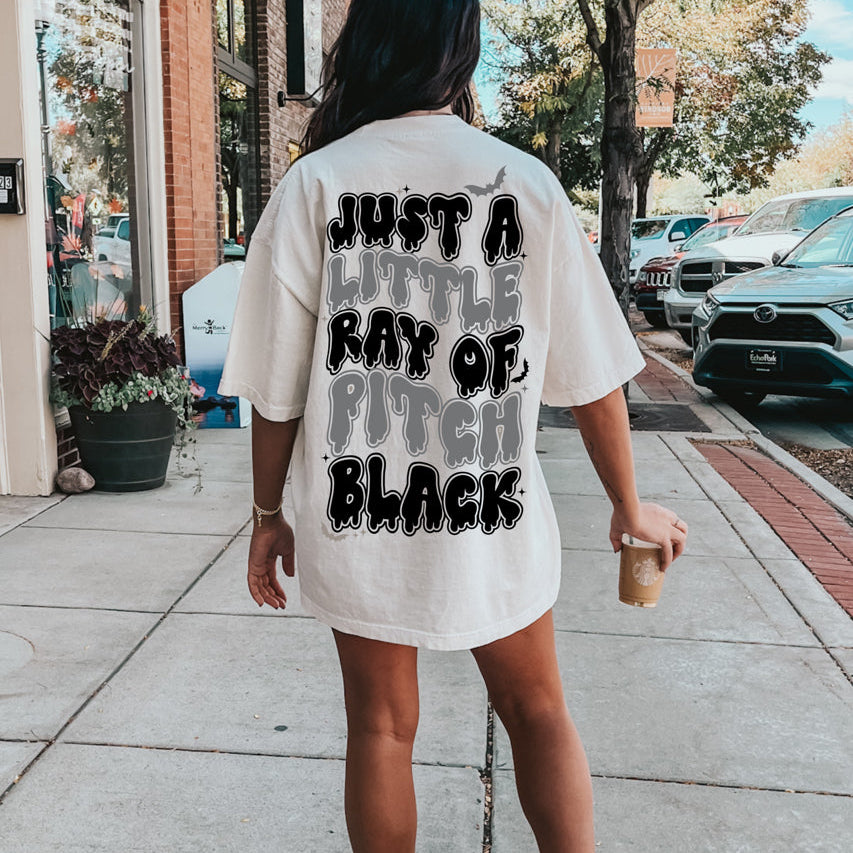 Ray of Pitch Black Graphic Tee from Shop Karma Tees, featuring a bold black t-shirt with a distinctive graphic design.