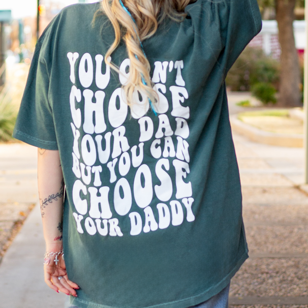 White graphic T-shirt from Shop Karma Tees with "Choose Your Daddy" design, casual fit and bold printed text.