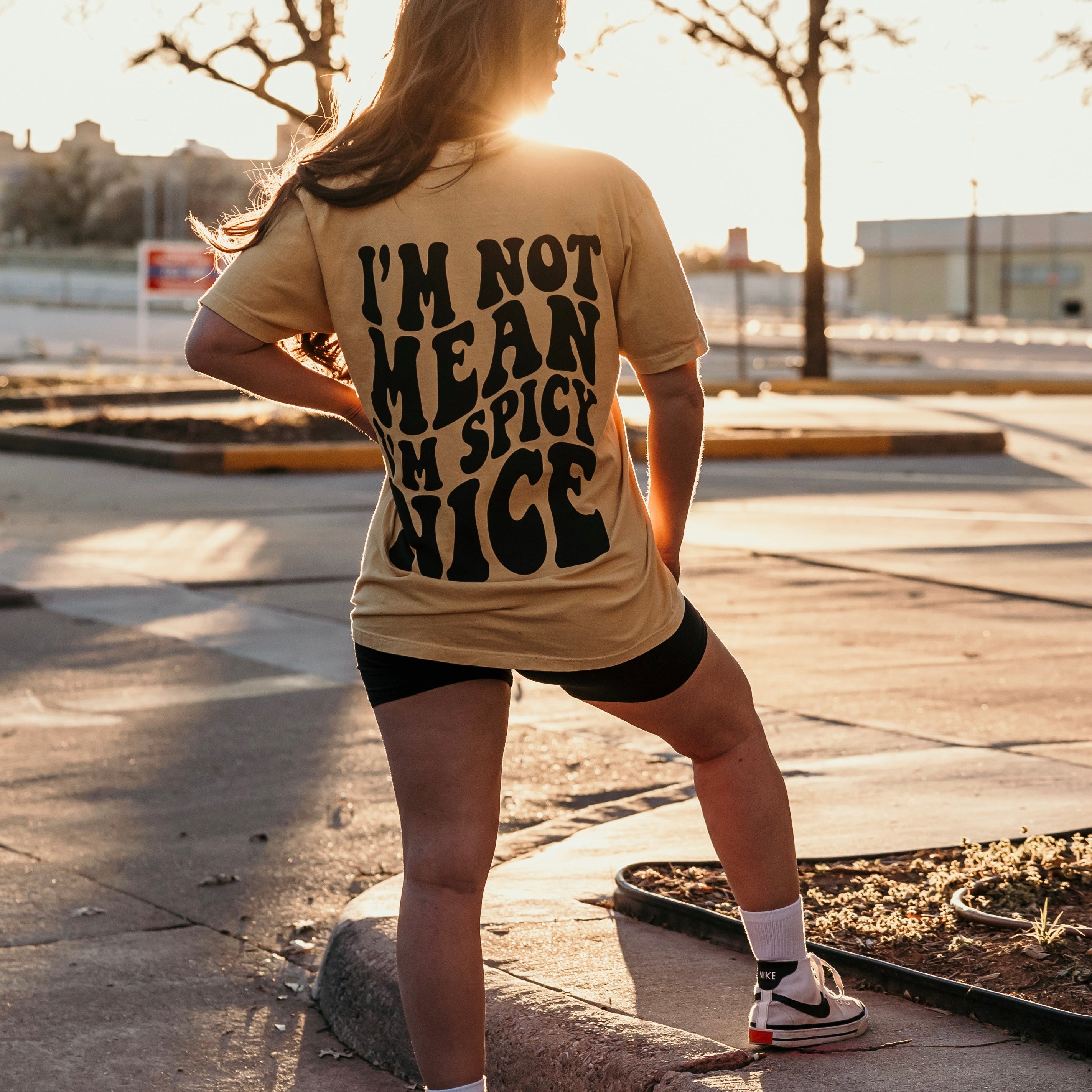 I'm Spicy Nice graphic T-shirt from Shop Karma Tees featuring bold lettering and vibrant spring-themed colors.