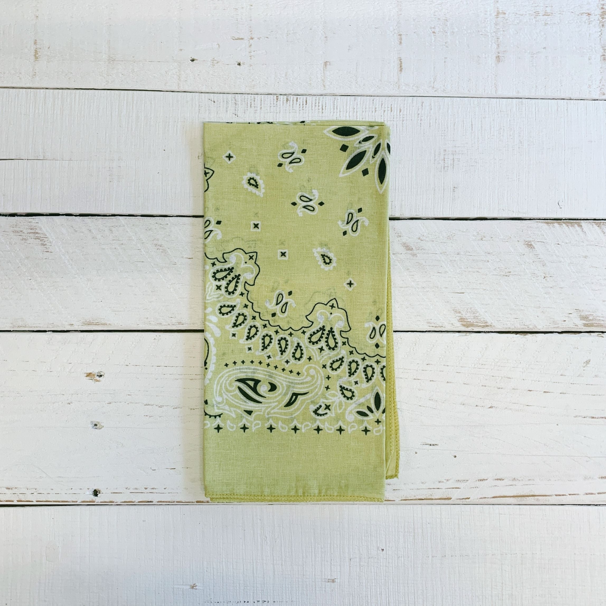 Muted lemon-colored boho bandana and headwrap from The Bullish Store, styled as a versatile hair scarf and headtie.