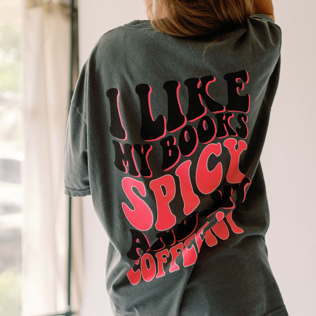Spicy Books graphic T-shirt by Shop Karma Tees featuring a bold spicy books design in black on a casual tee.
