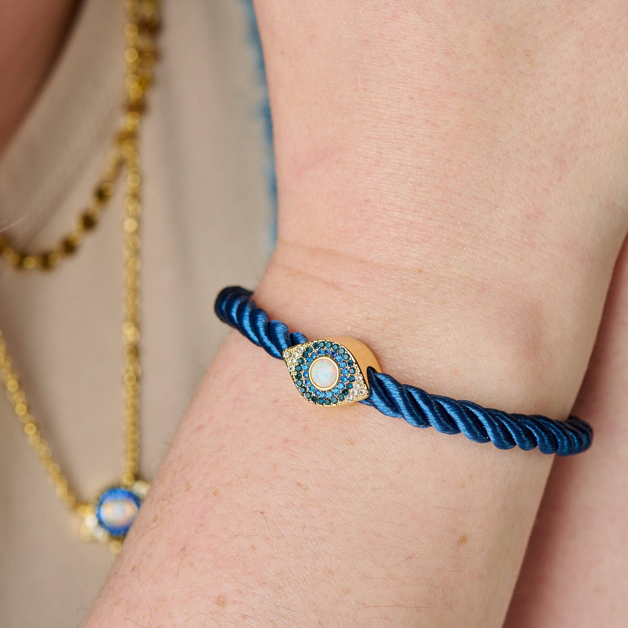 Gold Evil Eye adjustable cord bracelet by ALEX AND ANI featuring a detailed evil eye charm on a stylish cord band.