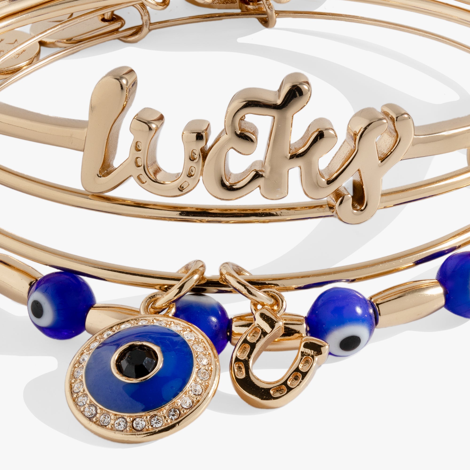 Set of three gold Evil Eye bangles by ALEX AND ANI, featuring protective eye charms and sleek bracelet design.