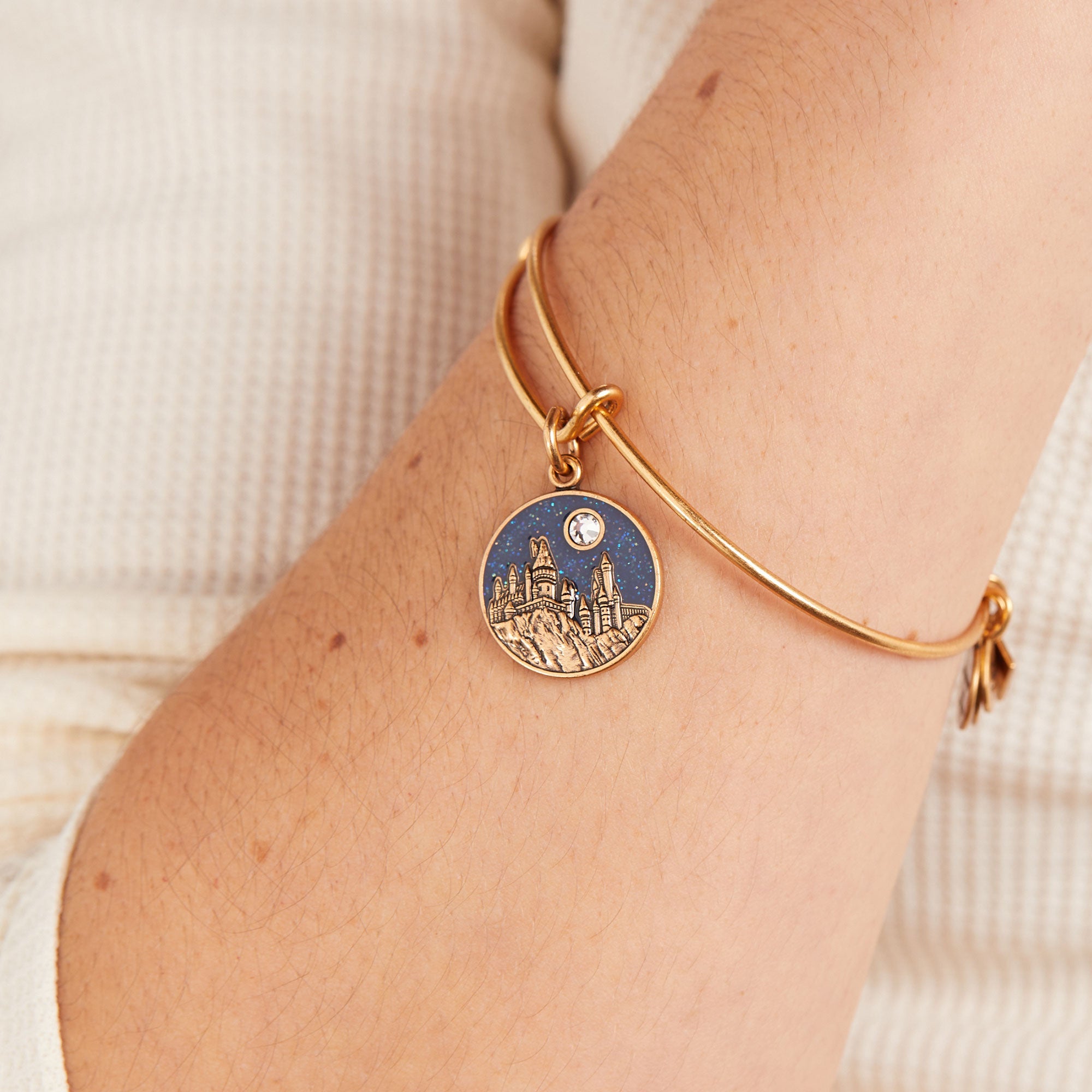 ALEX AND ANI Harry Potter Hogwarts Castle charm bangle featuring a detailed gold Harry Potter Hogwarts castle charm on a sleek bracelet.