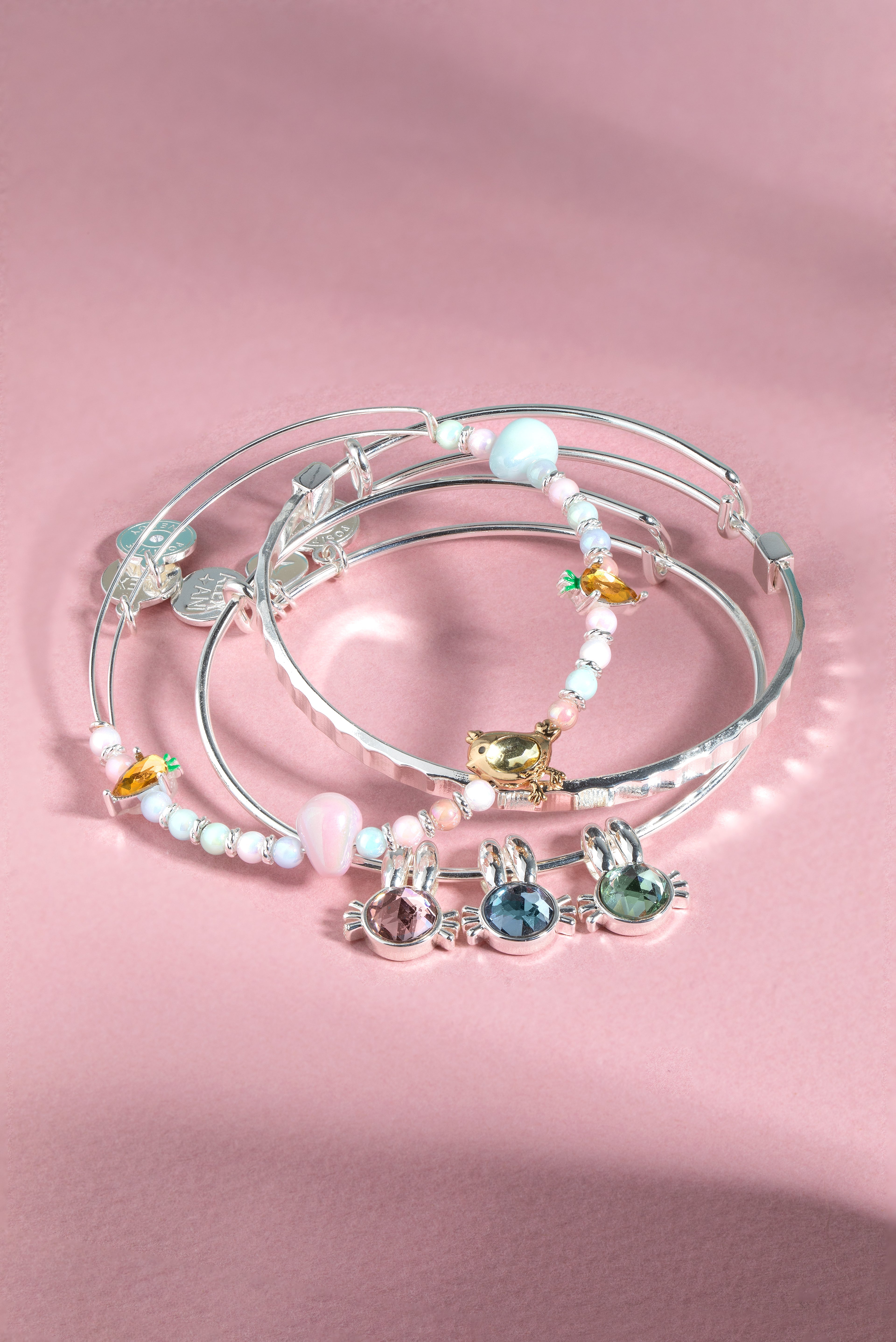 Set of three silver ALEX AND ANI crystal bunny bangle bracelets featuring delicate bunny charm designs.