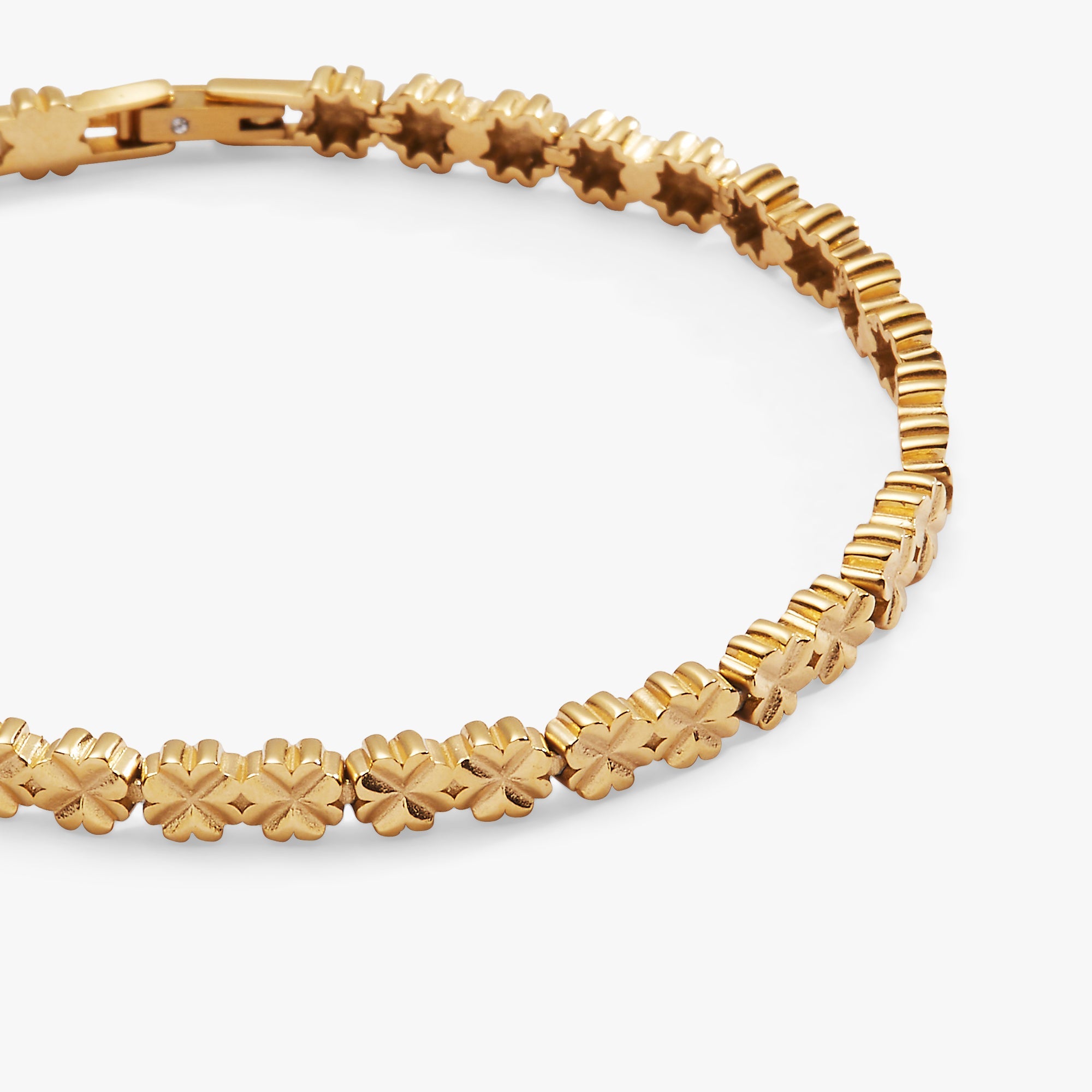 Gold stainless steel tennis bracelet with a lucky clover charm by ALEX AND ANI, featuring a delicate and elegant design.