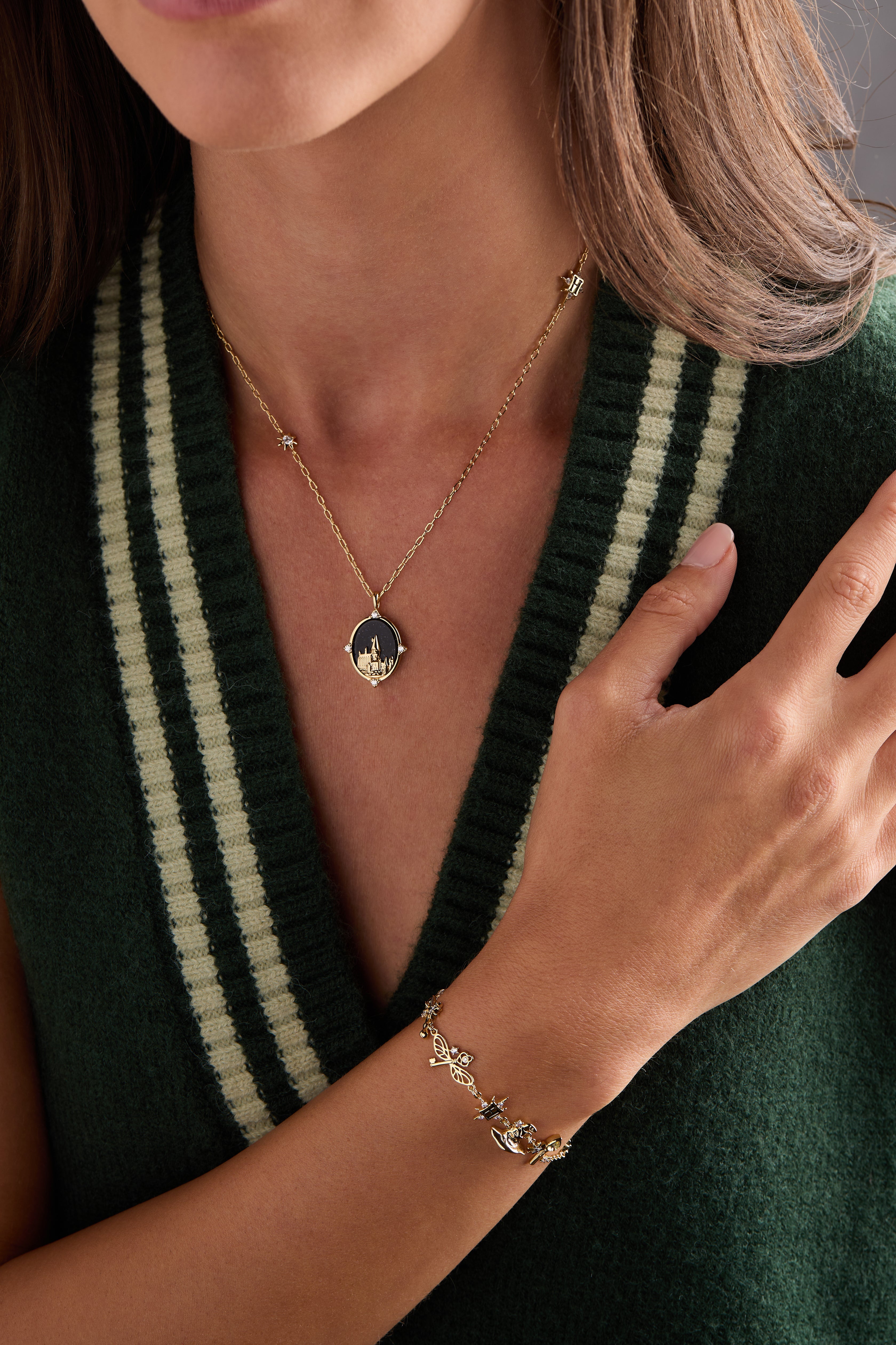 Gold Harry Potter Hogwarts pendant necklace from ALEX AND ANI featuring a detailed Hogwarts crest charm.