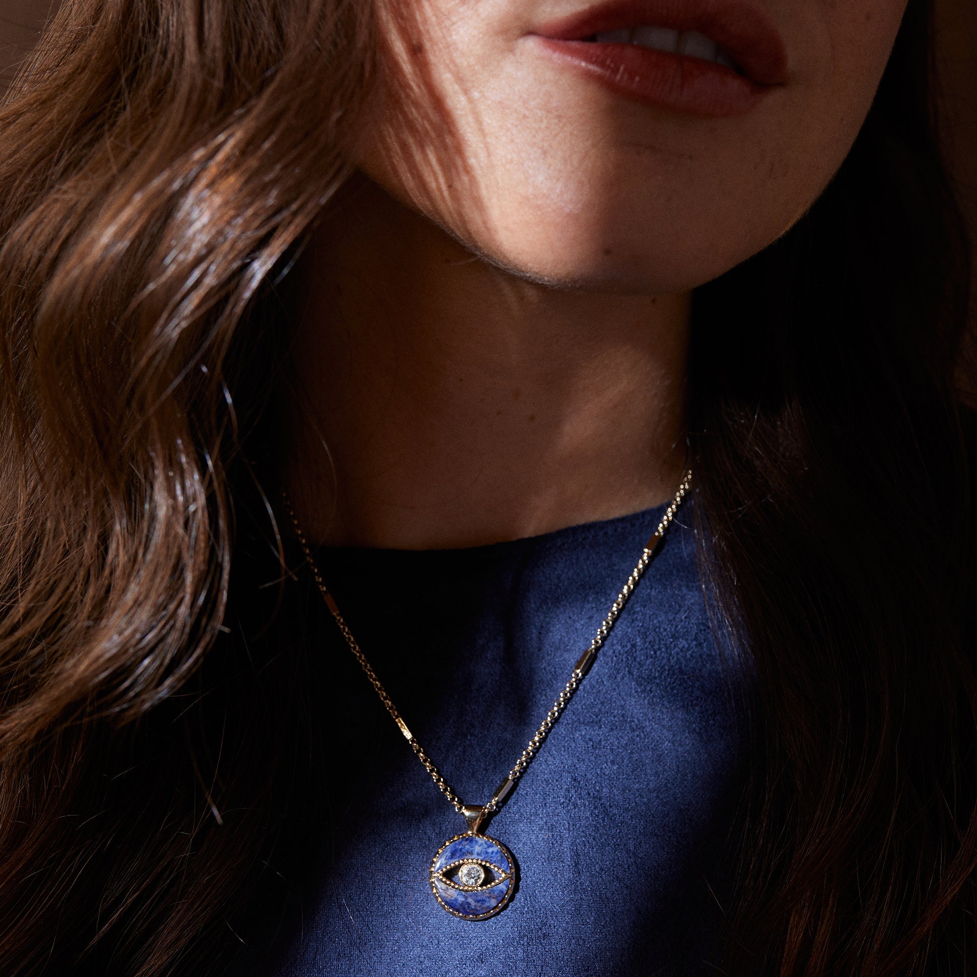 Gold Sodalite Evil Eye Necklace by ALEX AND ANI featuring a pendant with blue and white sodalite stones and an evil eye design.
