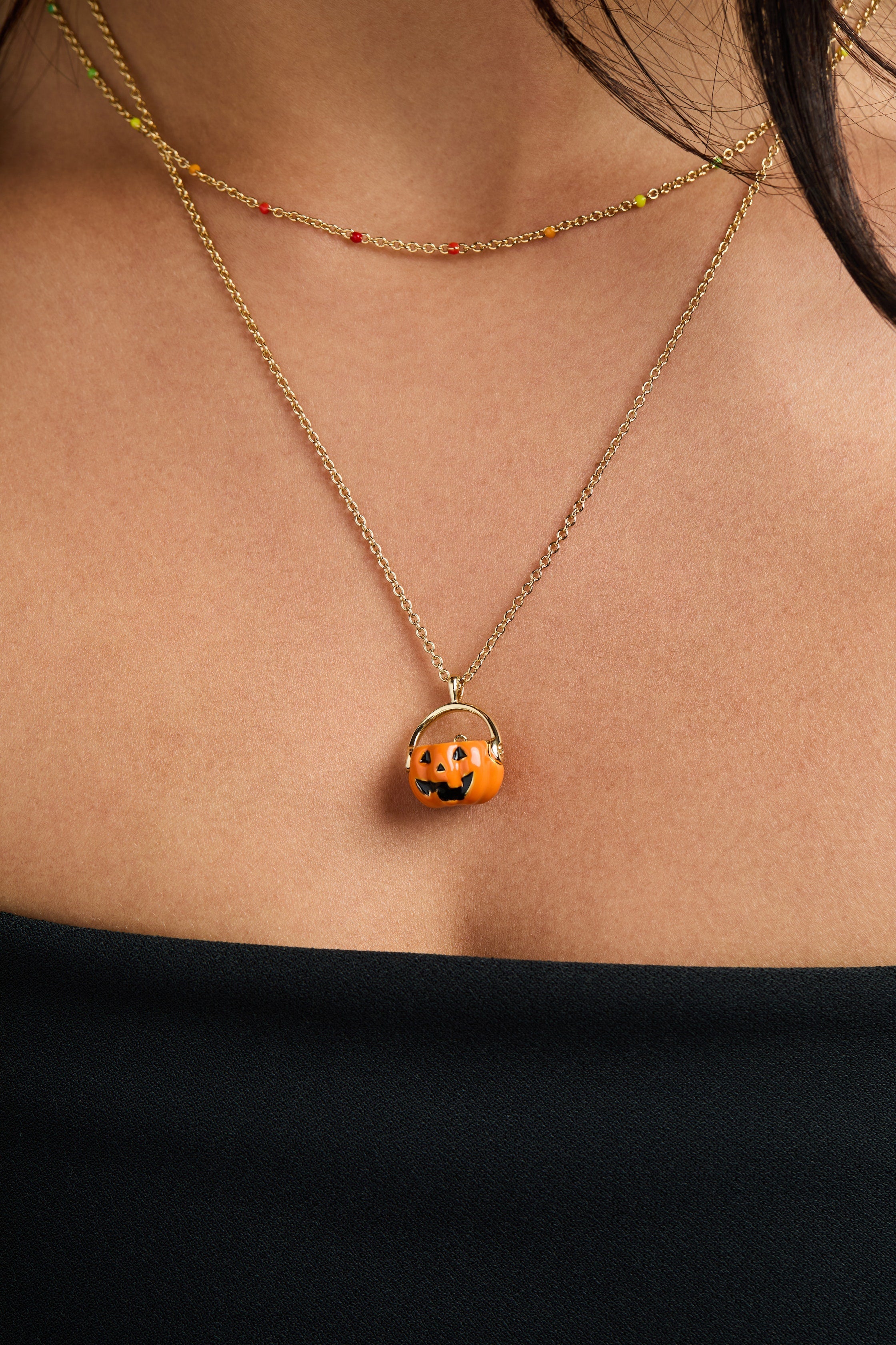 Gold 'Trick or Treat' layered necklace by ALEX AND ANI featuring Halloween-themed charms on delicate chains.