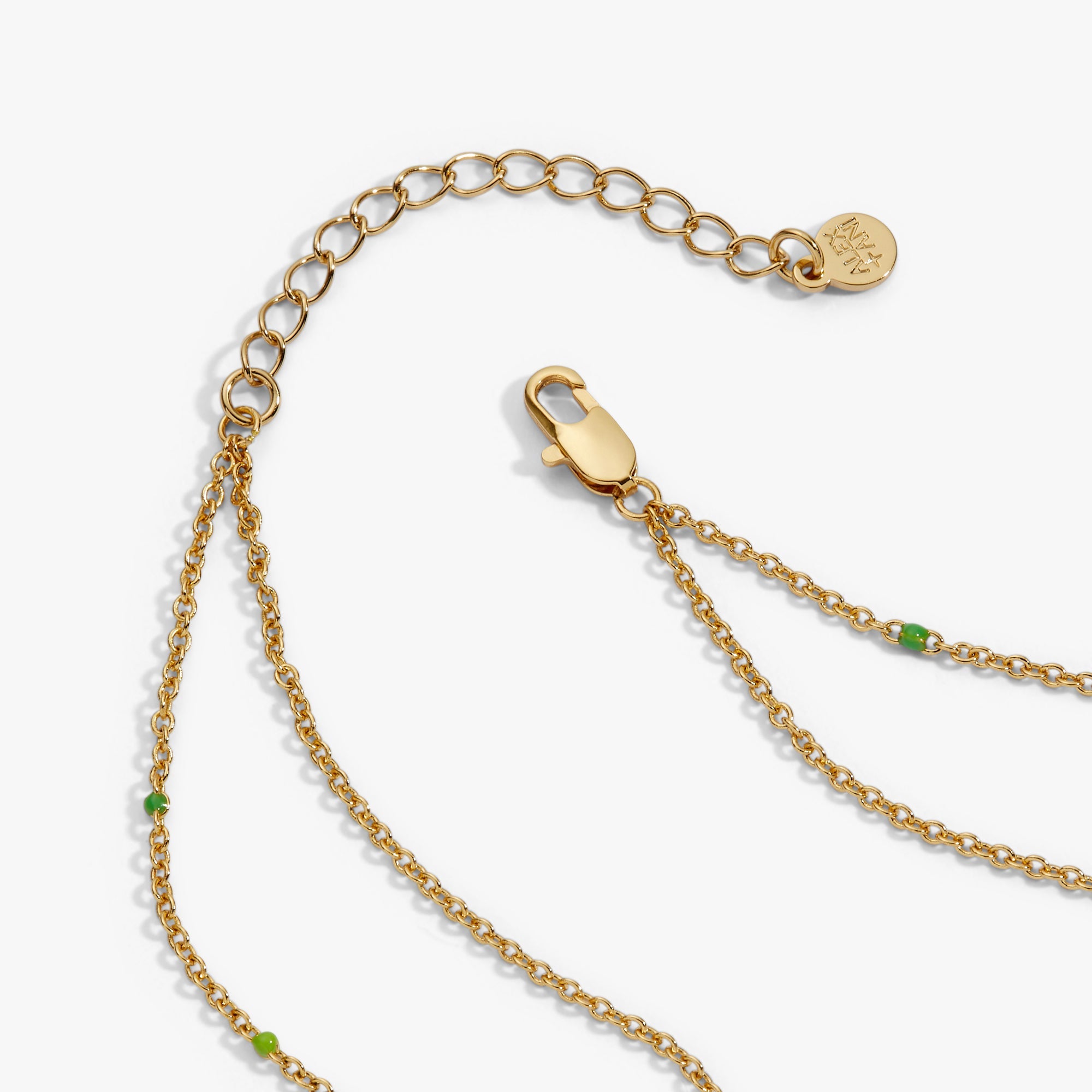 Gold 'Trick or Treat' layered necklace by ALEX AND ANI featuring festive Halloween-themed charms and delicate chain layers.