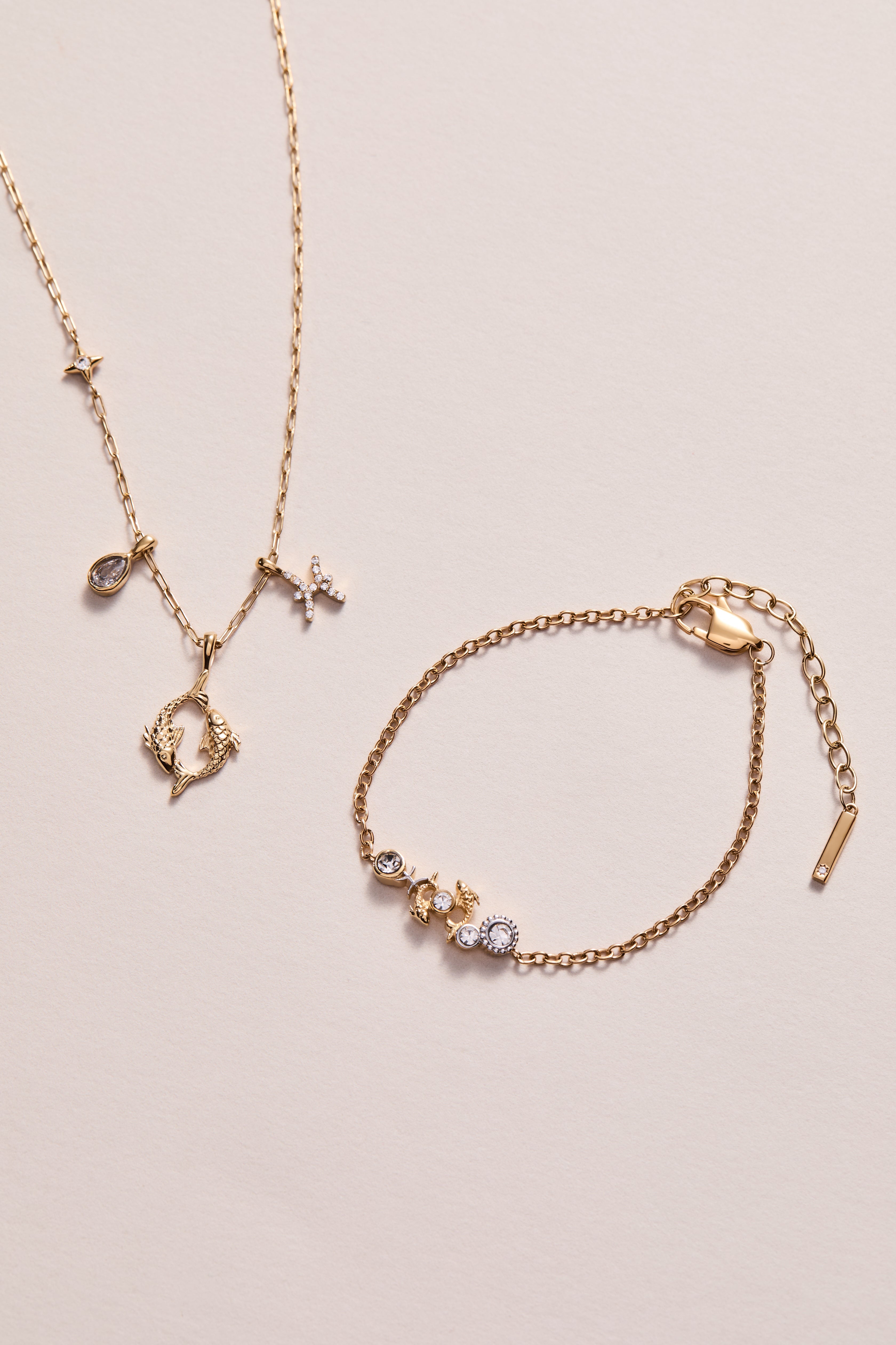 Gold stainless steel Pisces Zodiac Charm Cluster Necklace by ALEX AND ANI featuring a detailed Pisces pendant and layered chain design.