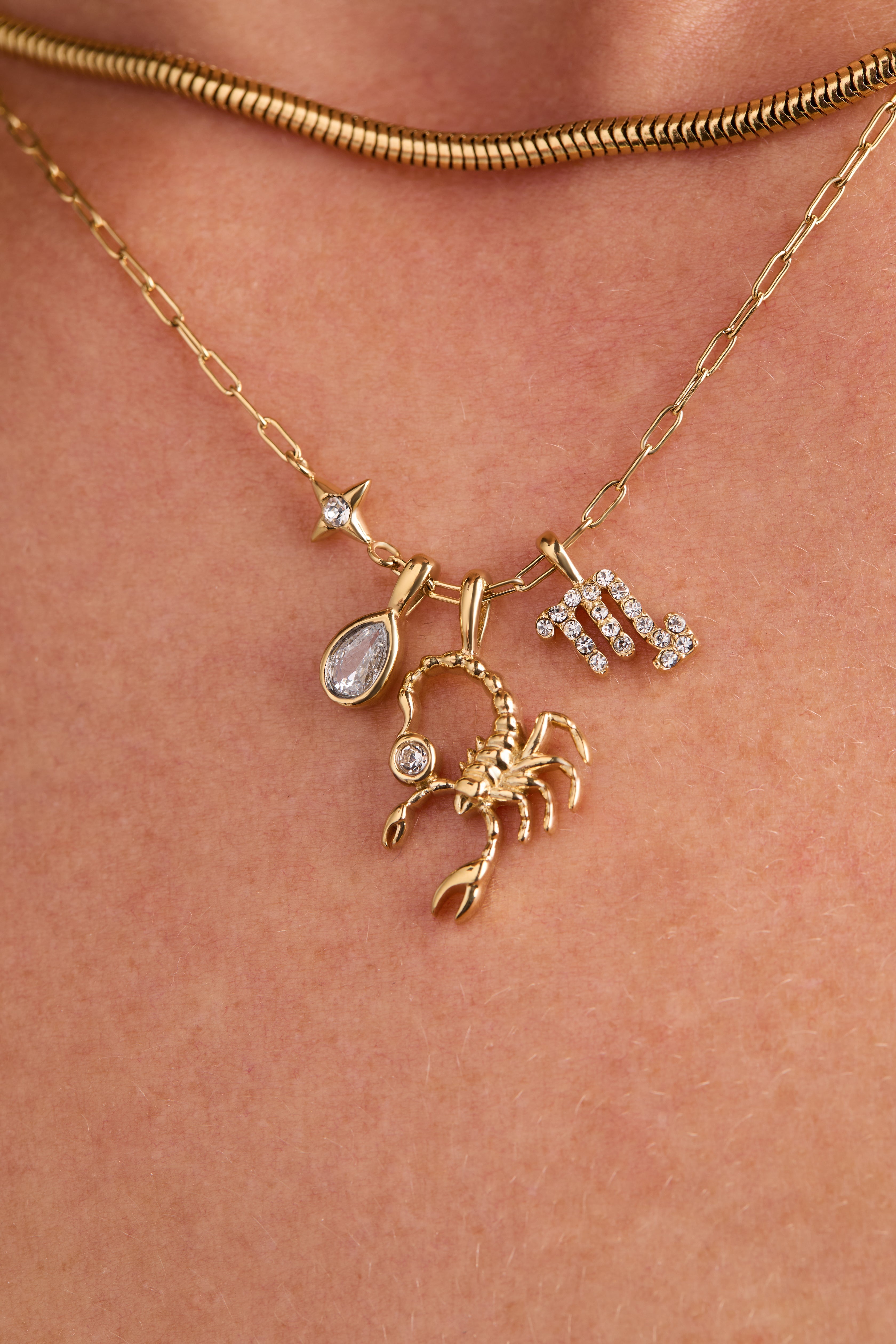 Gold stainless steel Scorpio Zodiac Charm Cluster Necklace from ALEX AND ANI, featuring a detailed Scorpio pendant on a chain.