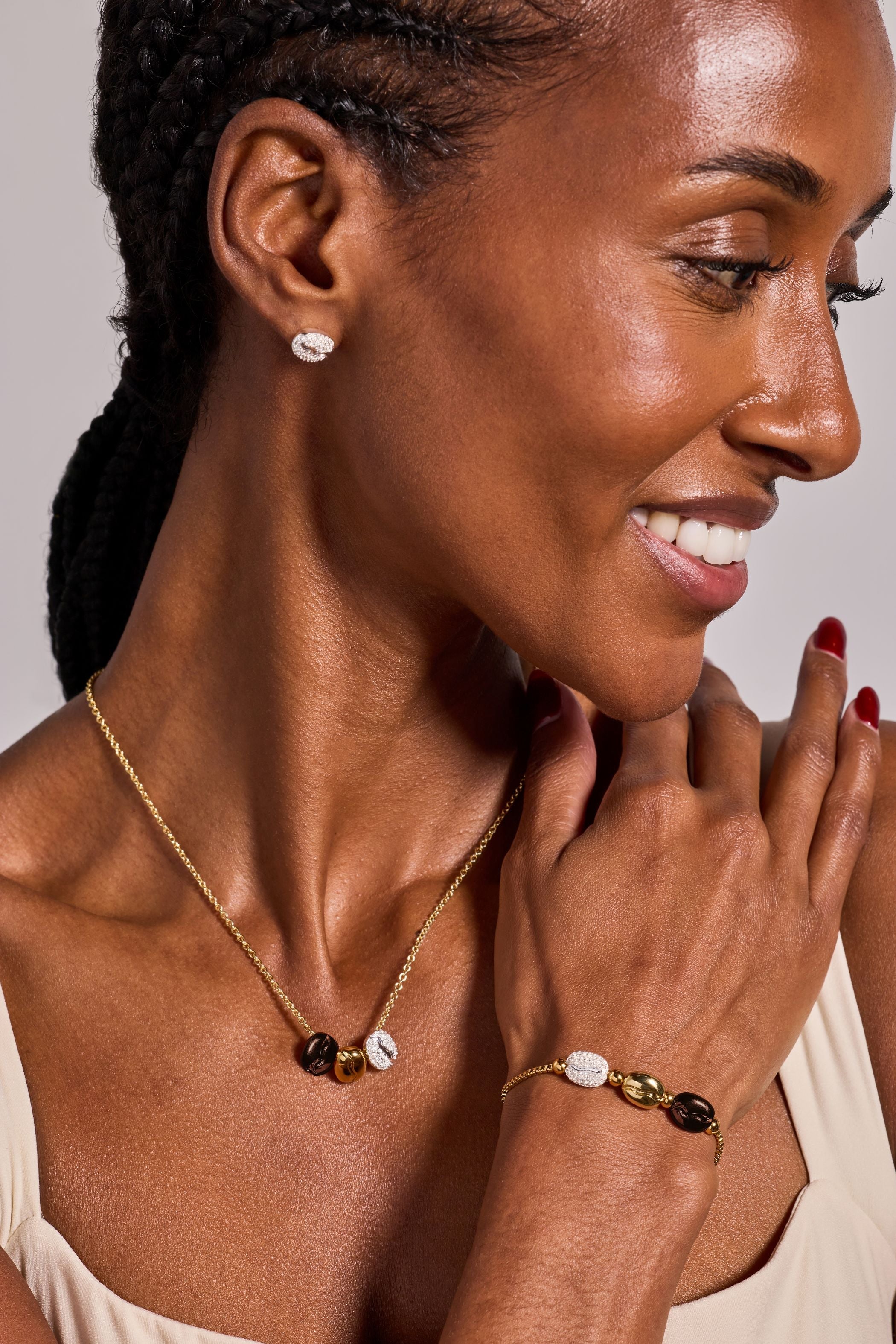 ALEX AND ANI tri-tone coffee bean pendant necklace engraved with "Happiness, Wealth, Health" on a delicate chain.