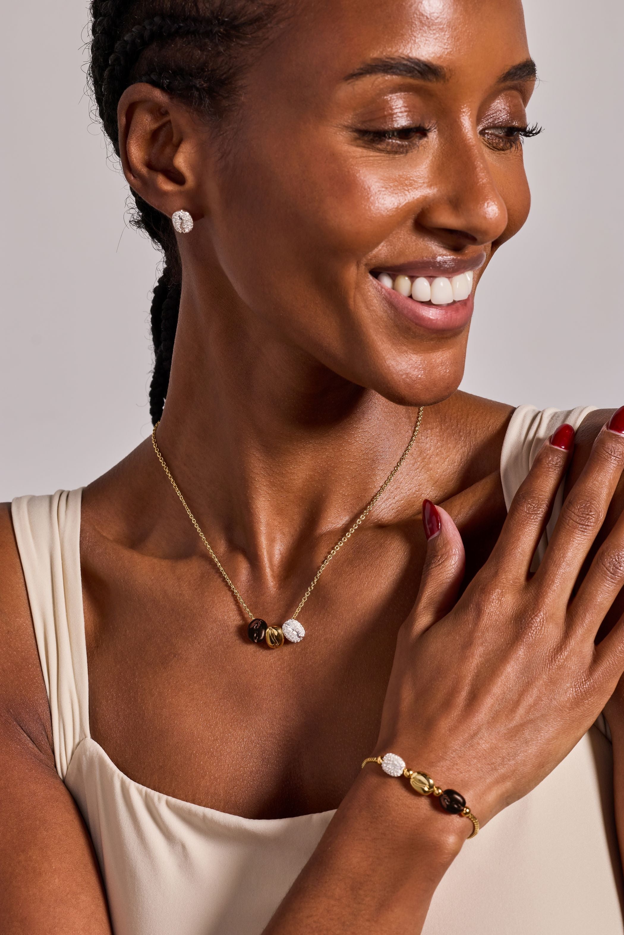 Tri-tone engraved pendant necklace featuring a coffee bean with "Happiness, Wealth, Health" inscribed, by ALEX AND ANI.