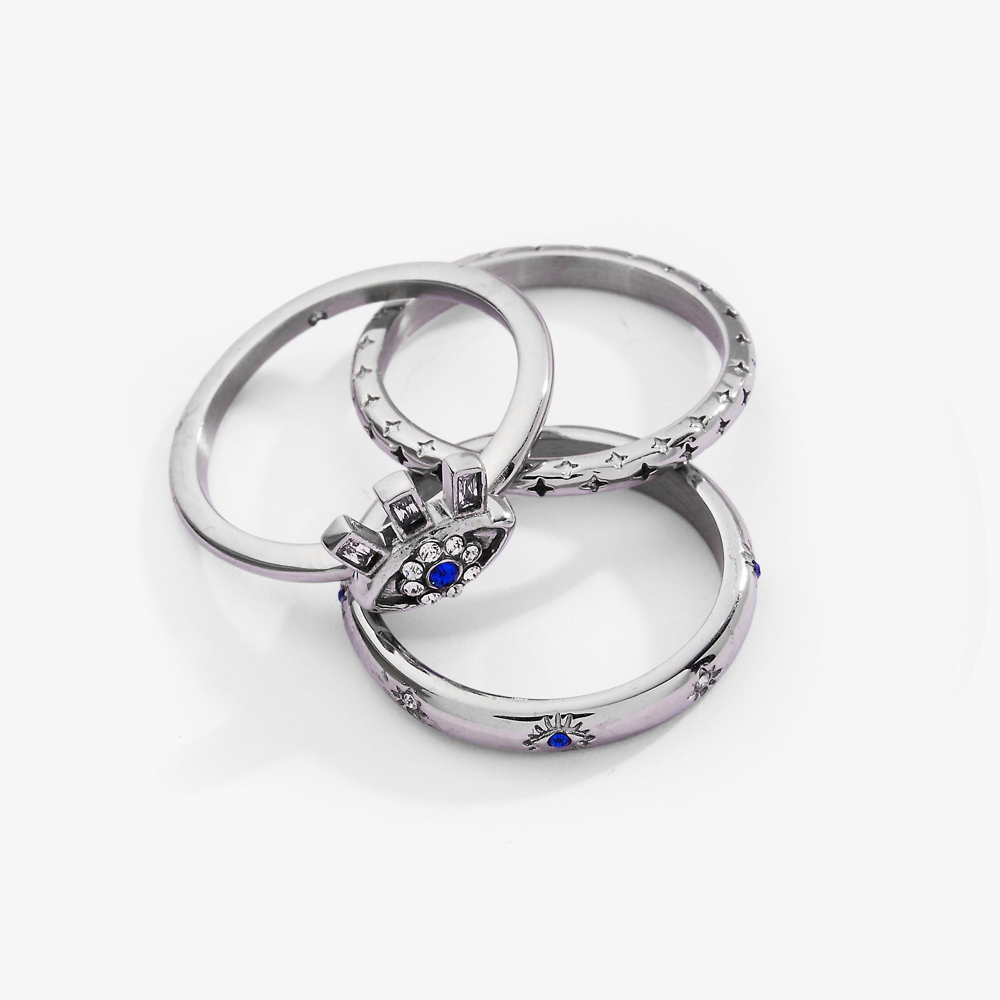 Set of three gold stainless steel Evil Eye stacking rings by ALEX AND ANI, featuring eye motifs and sleek design.
