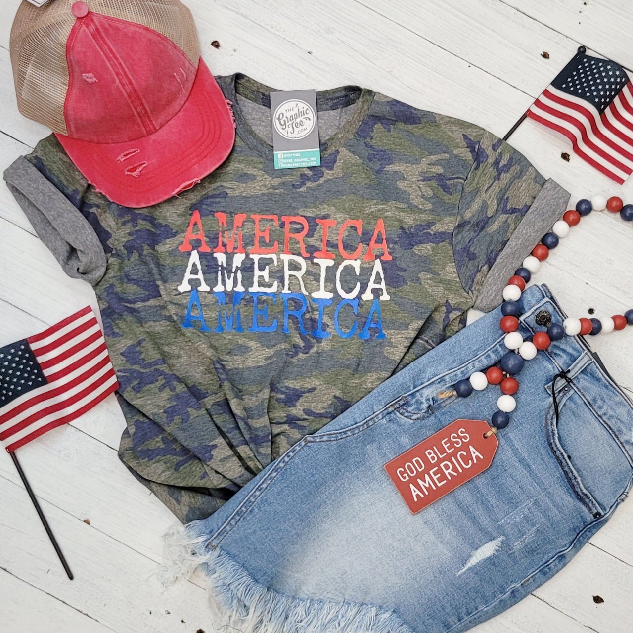 America America America camouflage short sleeve graphic T-shirt by The Graphic Tee, featuring bold patriotic design.