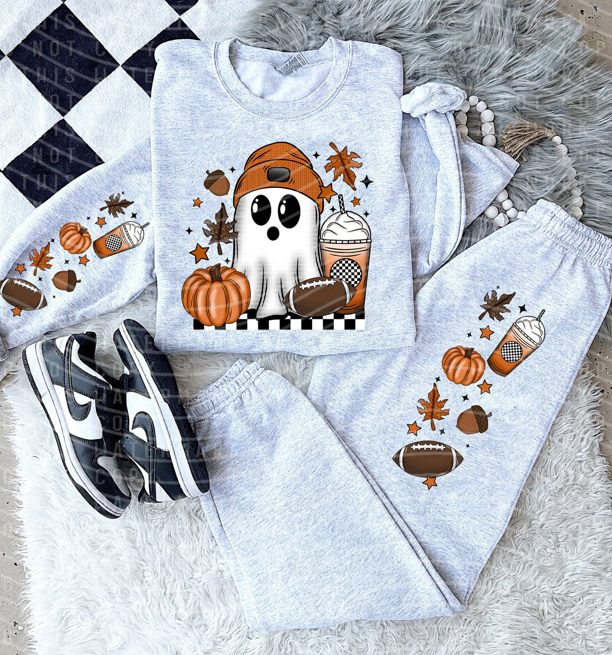 Black football ghost graphic tee from Anchored Grace Boutique, featuring a playful football and ghost design on a casual graphic tee.