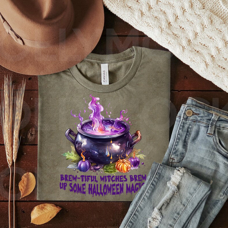 Black graphic tee from Anchored Grace Boutique featuring a Halloween witch brew design with spooky, colorful lettering.