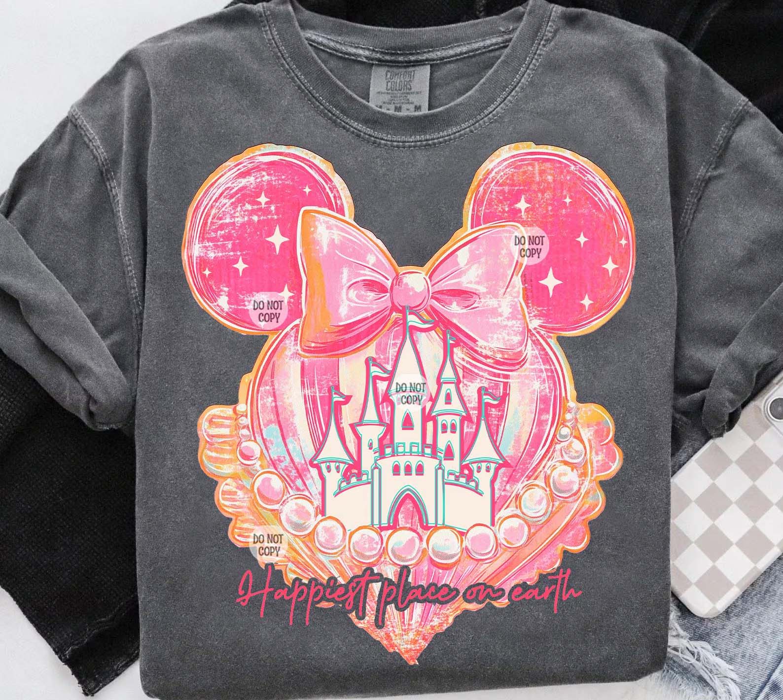 Black graphic tee featuring "Happiest Place on Earth" design from Anchored Grace Boutique, casual wear with colorful print.
