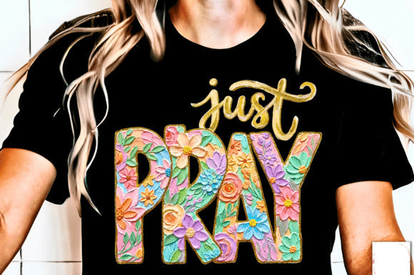 Black Just Pray graphic tee by Anchored Grace Boutique featuring a spiritual design and bold lettering on soft cotton fabric.