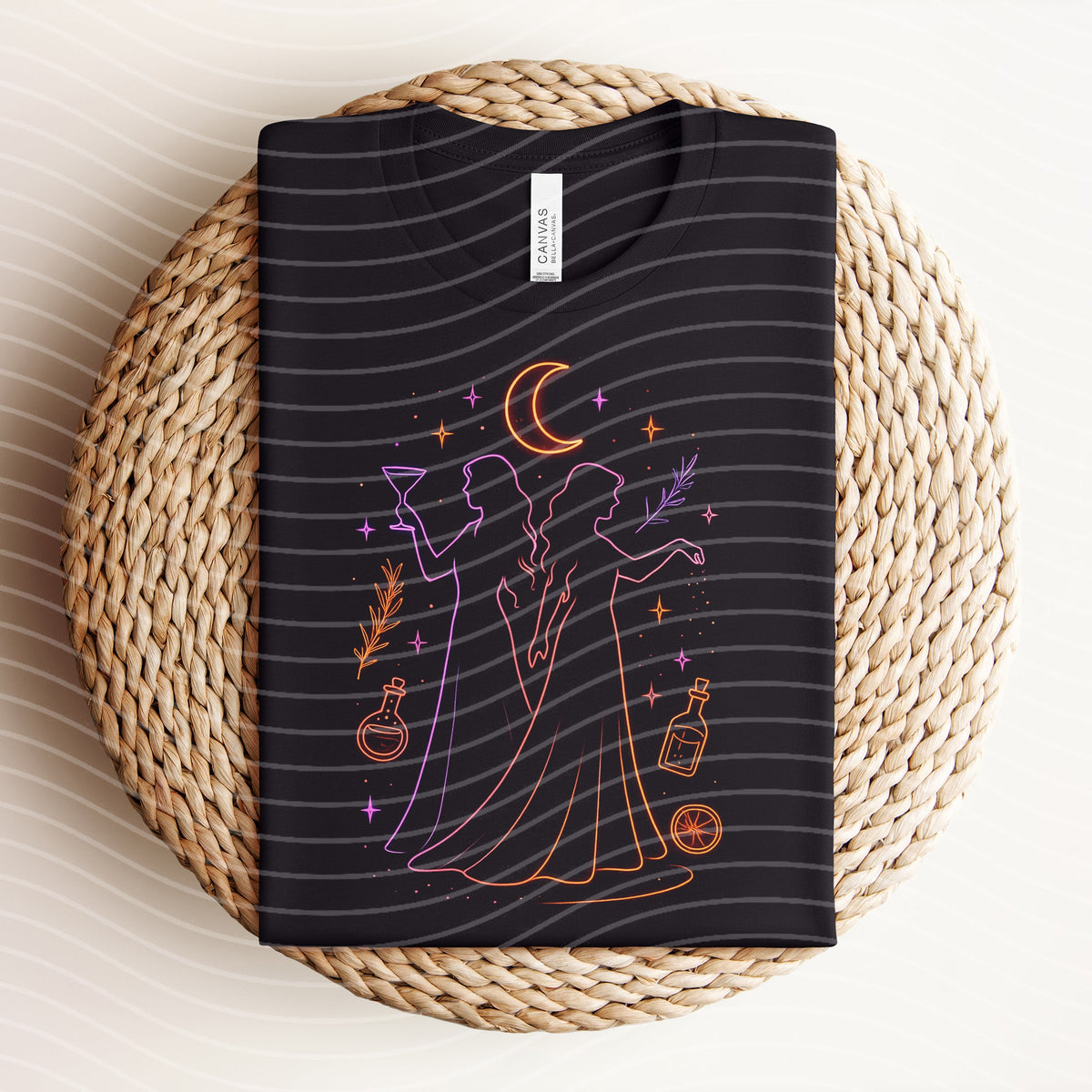Practical Magic neon graphic tee by Anchored Grace Boutique, featuring colorful witch-themed design on a casual cotton t-shirt.