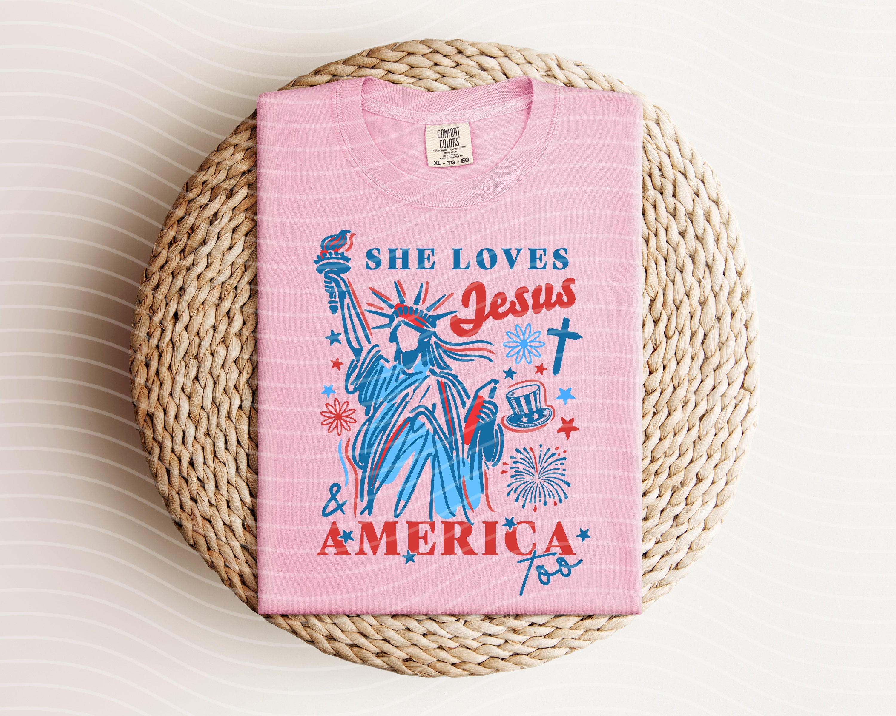 Graphic tee from Anchored Grace Boutique featuring "She Loves Jesus and America Too" design on soft fabric.