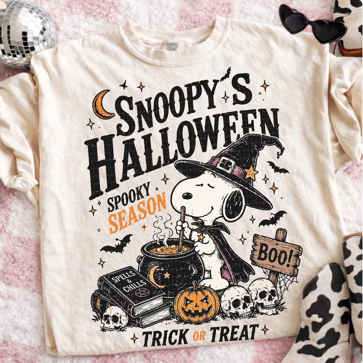 Snoopy Halloween graphic tee from Anchored Grace Boutique featuring Snoopy with a spooky Halloween design, casual short-sleeve shirt.