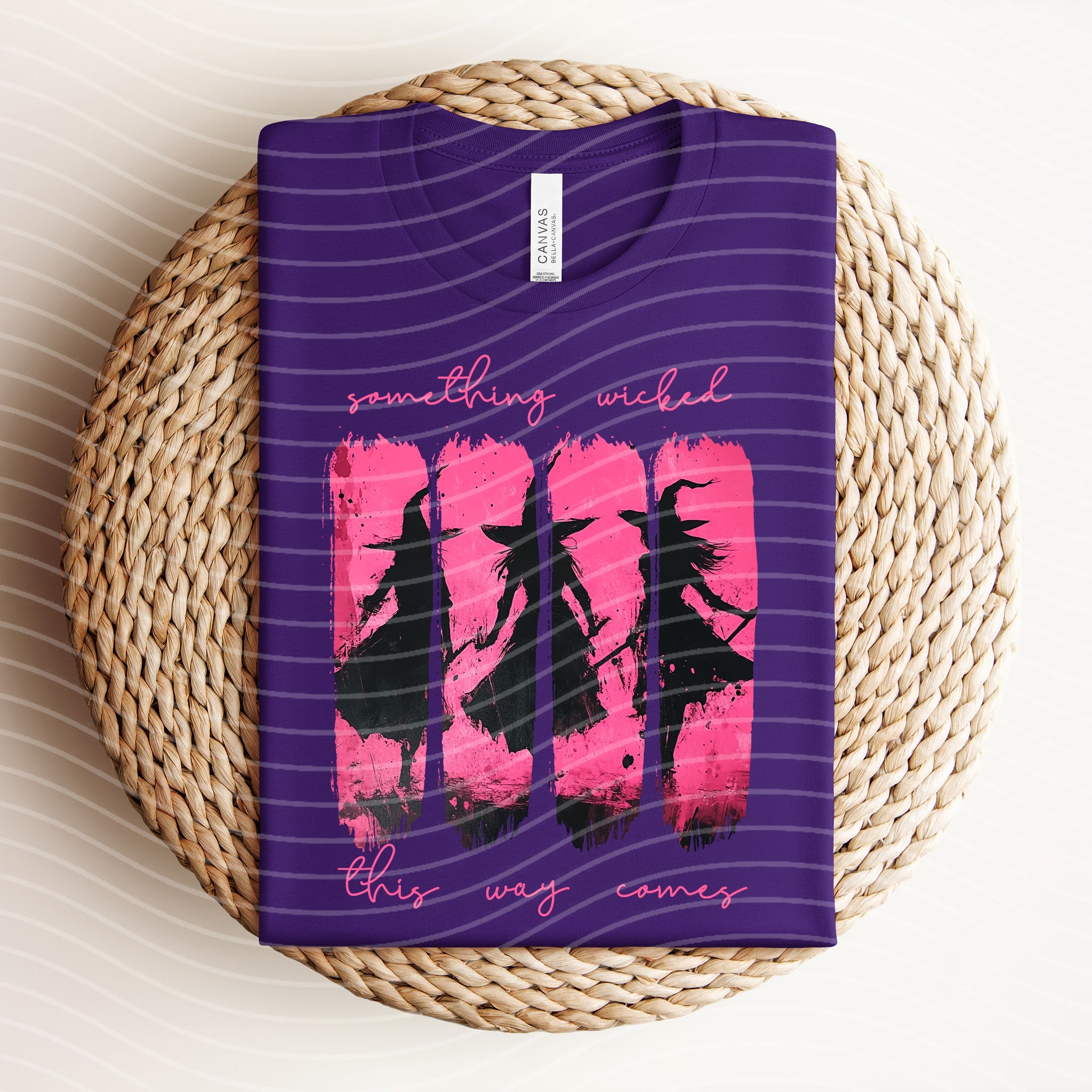 Black graphic tee from Anchored Grace Boutique featuring "Something Wicked This Way Comes" spooky text and design.