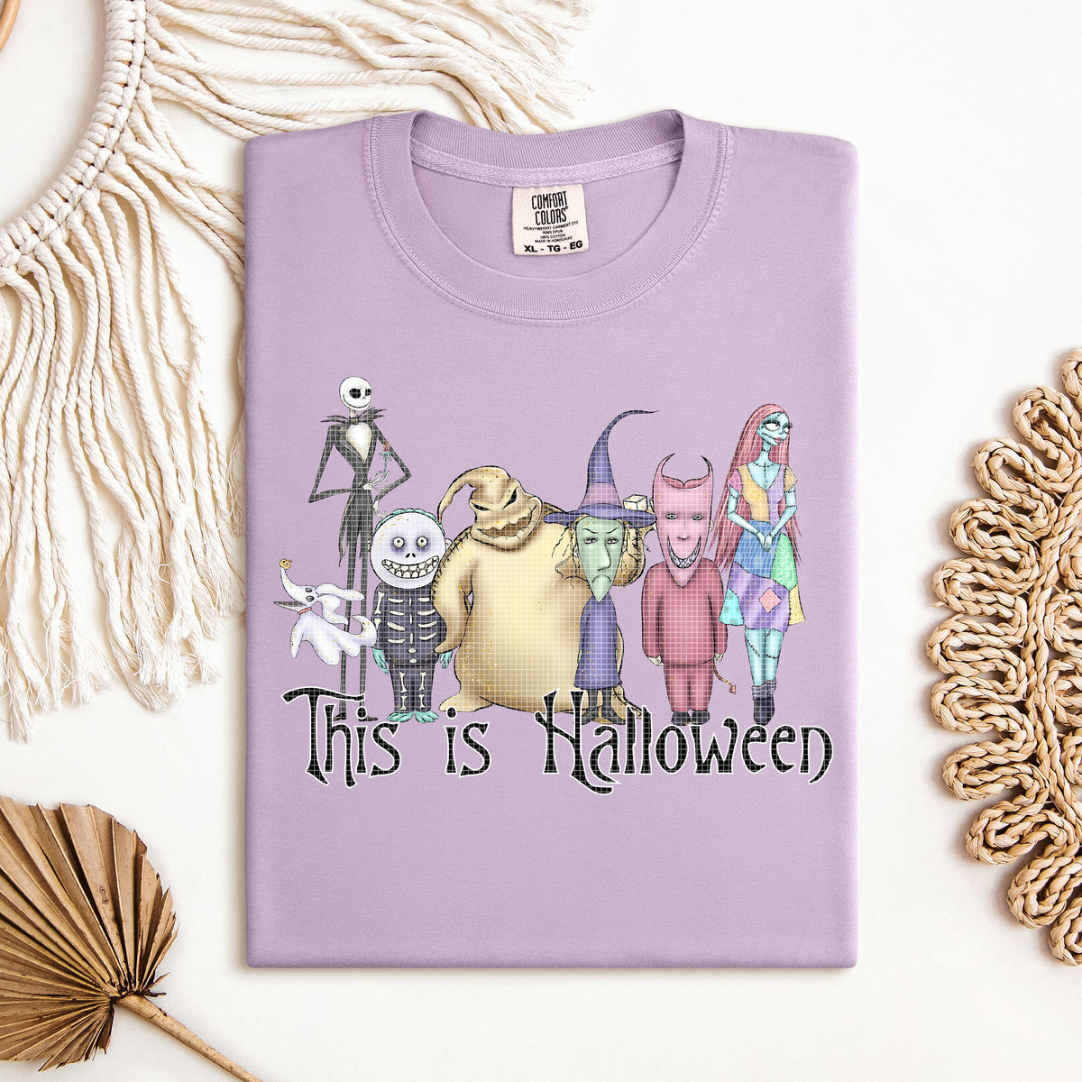 Halloween graphic tee by Anchored Grace Boutique featuring spooky seasonal design on a casual t-shirt.