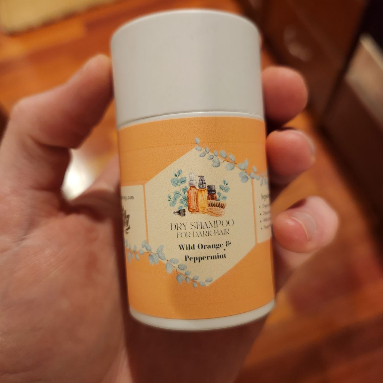 Ancient Health & Healings all-natural dry shampoo powder for light hair, in a clear container with white powder visible.