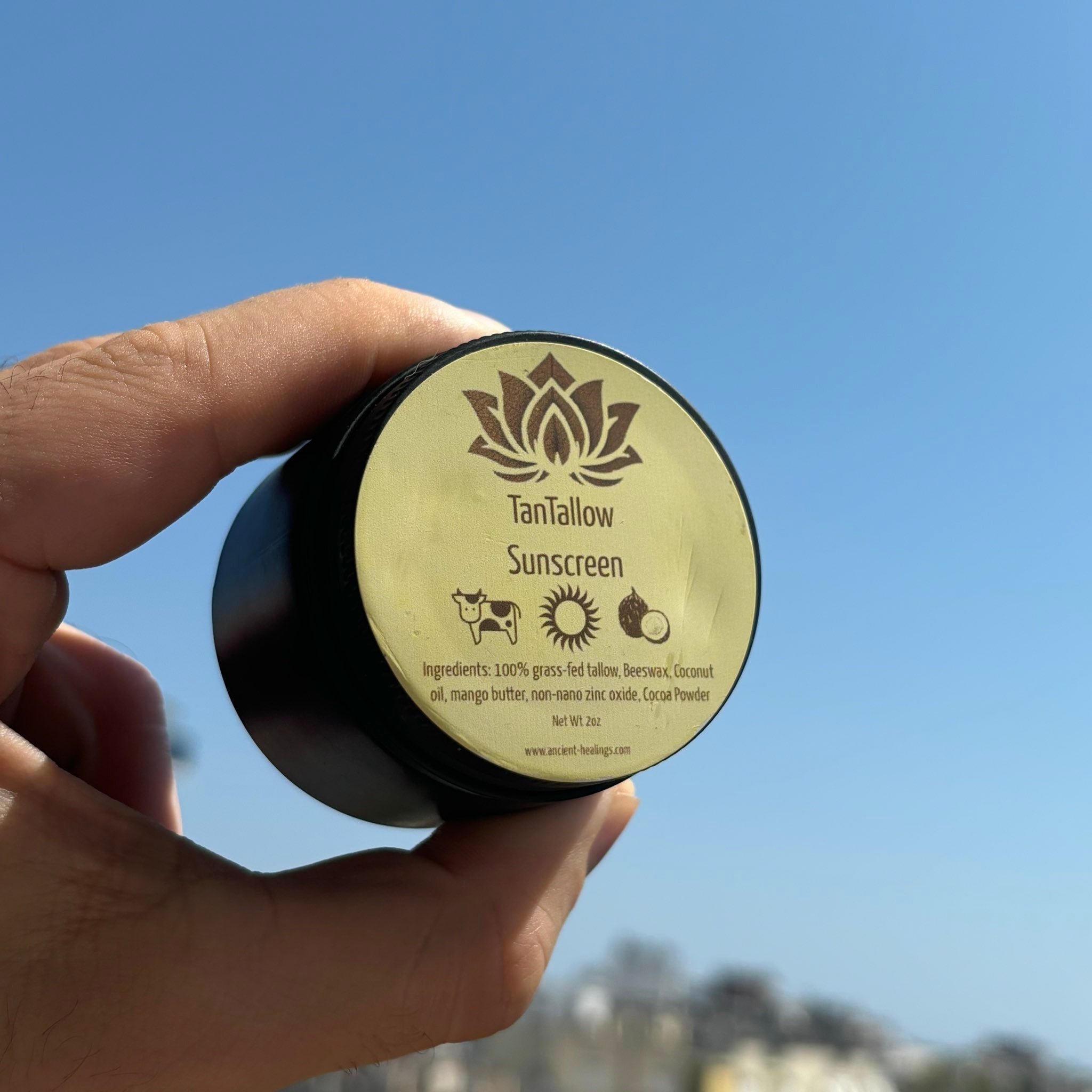 Ancient Health & Healings TanTallow Mineral Sunscreen in a 2oz bottle, natural tan-colored sunscreen with SPF protection.