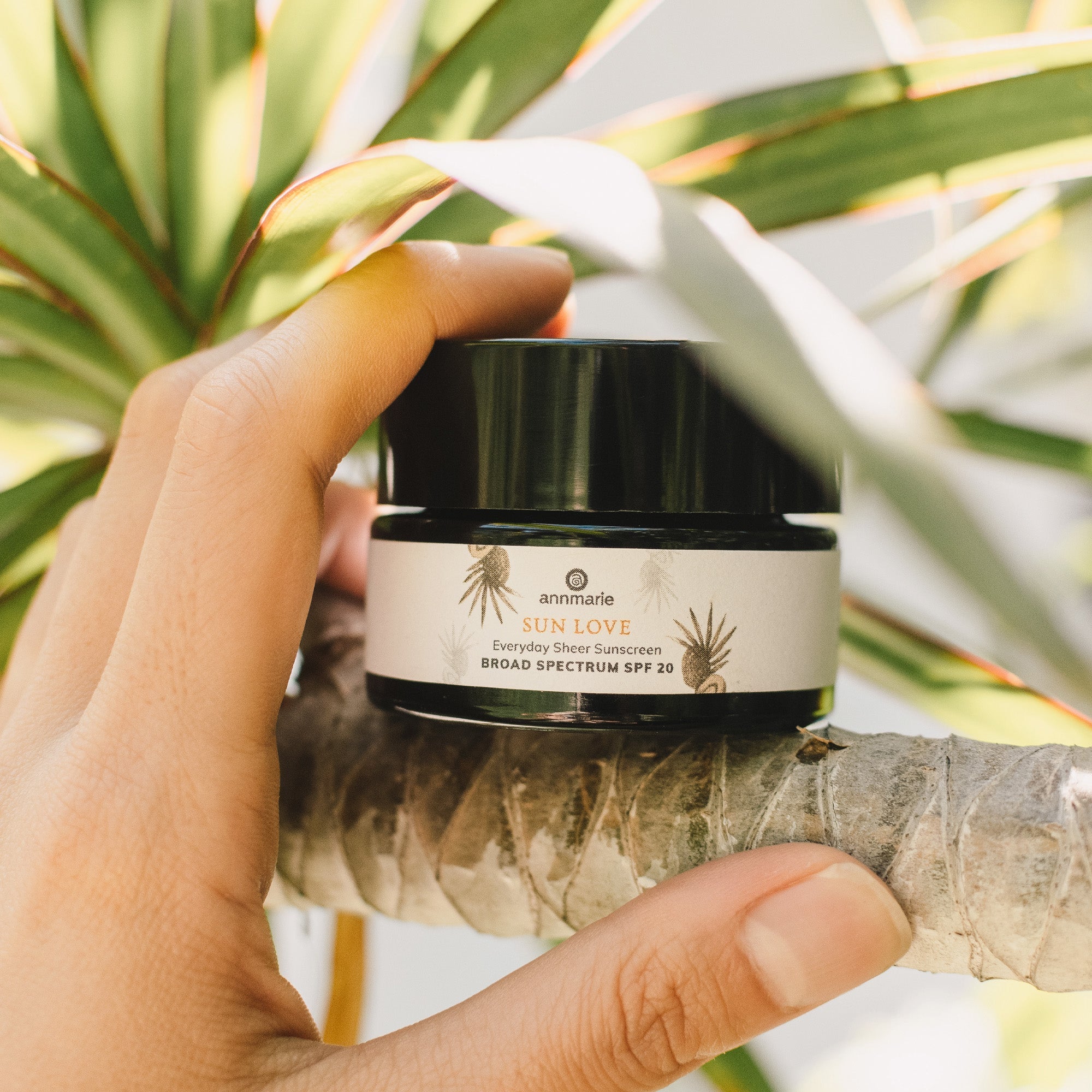 Deluxe Mini Sun Love 30ml from Annmarie Skin Care, a natural skincare product with a small, elegant container.