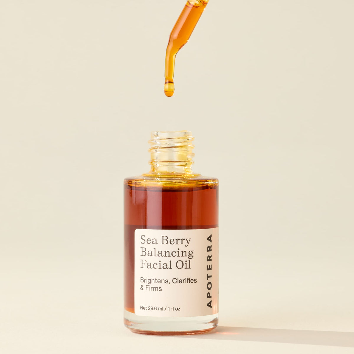 Dropper of Apoterra Sea Berry Balancing Facial Oil showing the natural oil in a glass bottle with a dropper applicator.