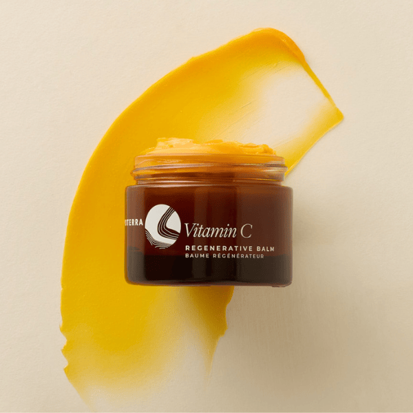 Apoterra Vitamin C Regenerative Balm facial oil in a glass jar, with a smooth, creamy texture and natural ingredients visible.