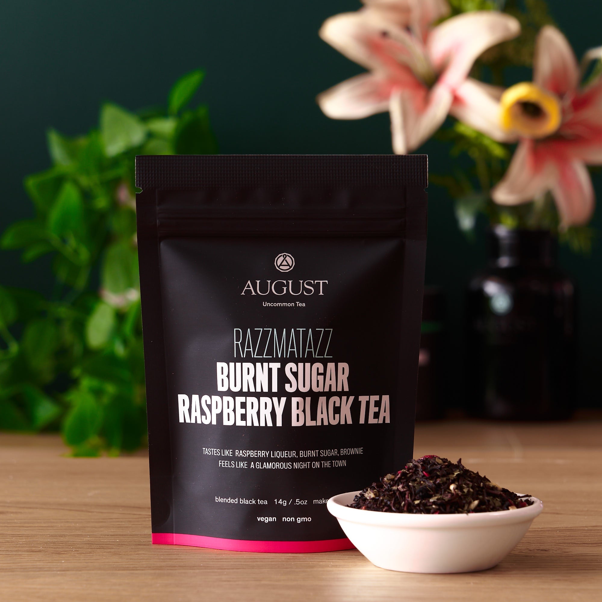 Razzmatazz Raspberry Burnt Sugar Black Tea by August Uncommon Tea in a 15-cup bag, showcasing the tea packaging with branding and product details.