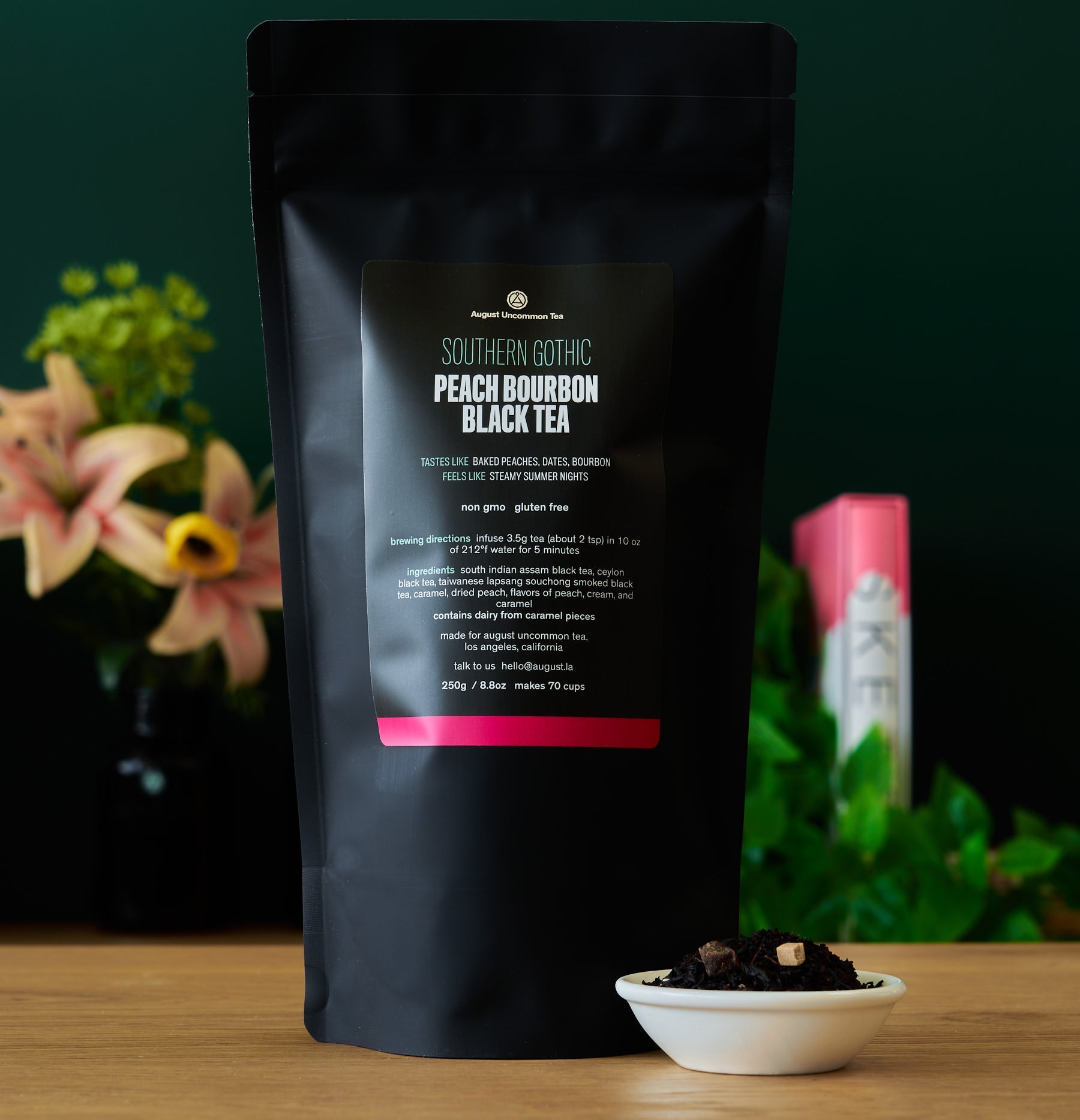 Black tea bag labeled Southern Gothic Peach Bourbon Black Tea from August Uncommon Tea, featuring a dark tea bag with branding.