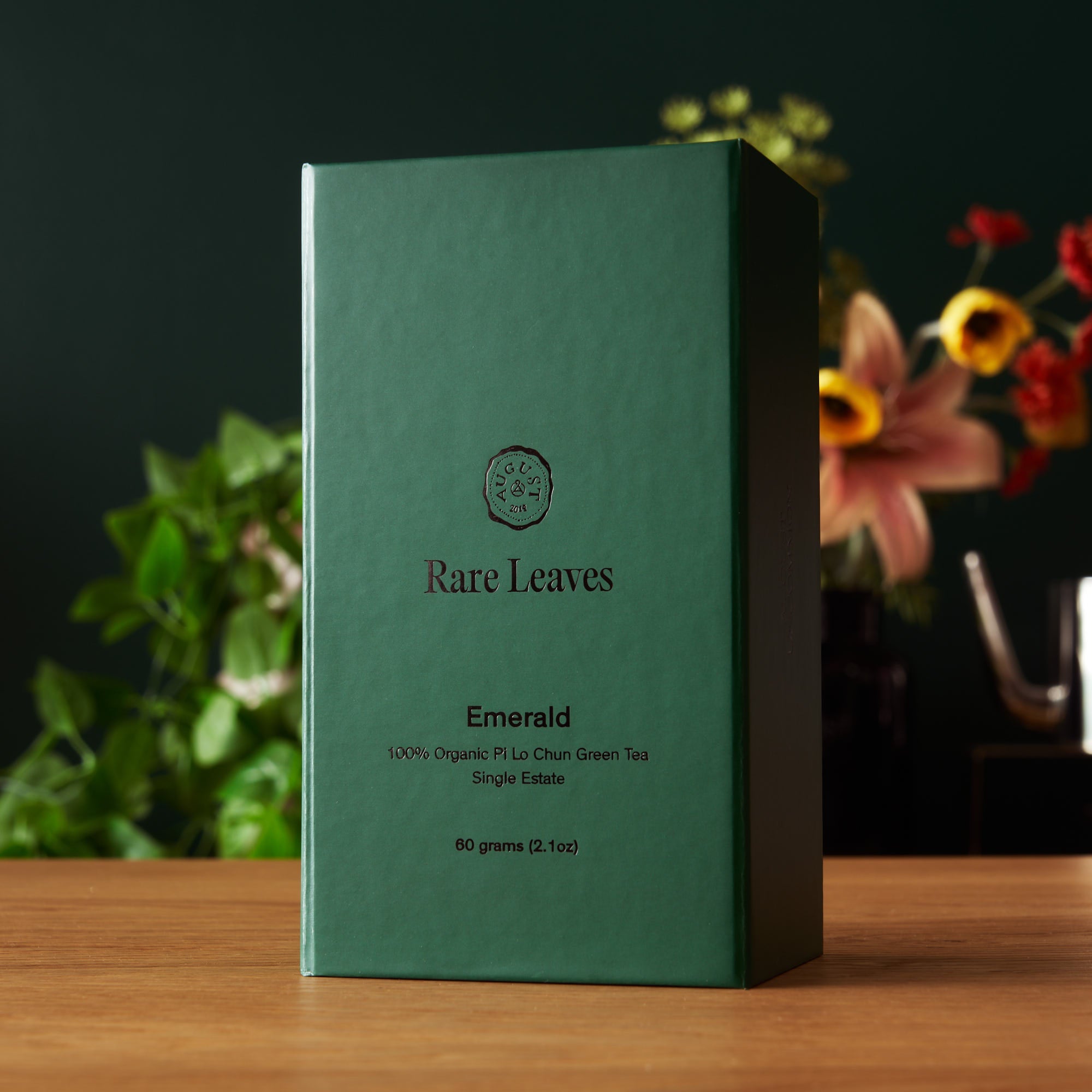 August Uncommon Tea Rare Leaves Emerald Pi Lo Chun green tea in 60g tin, showcasing fresh, twisted green tea leaves from single estate.
