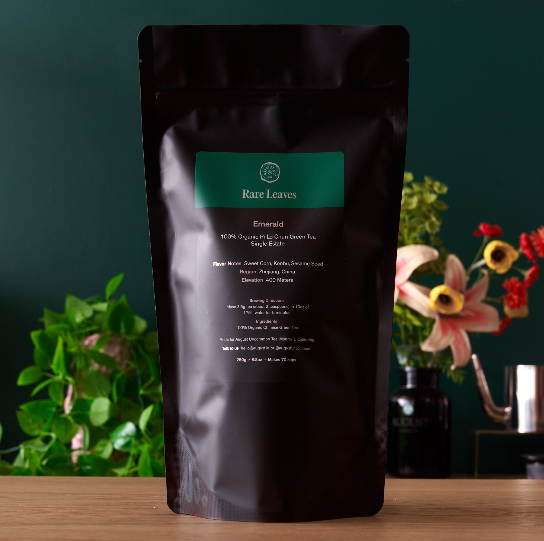 August Uncommon Tea Rare Leaves Emerald Pi Lo Chun green tea in a 60g tin, showcasing fresh, rolled green tea leaves.