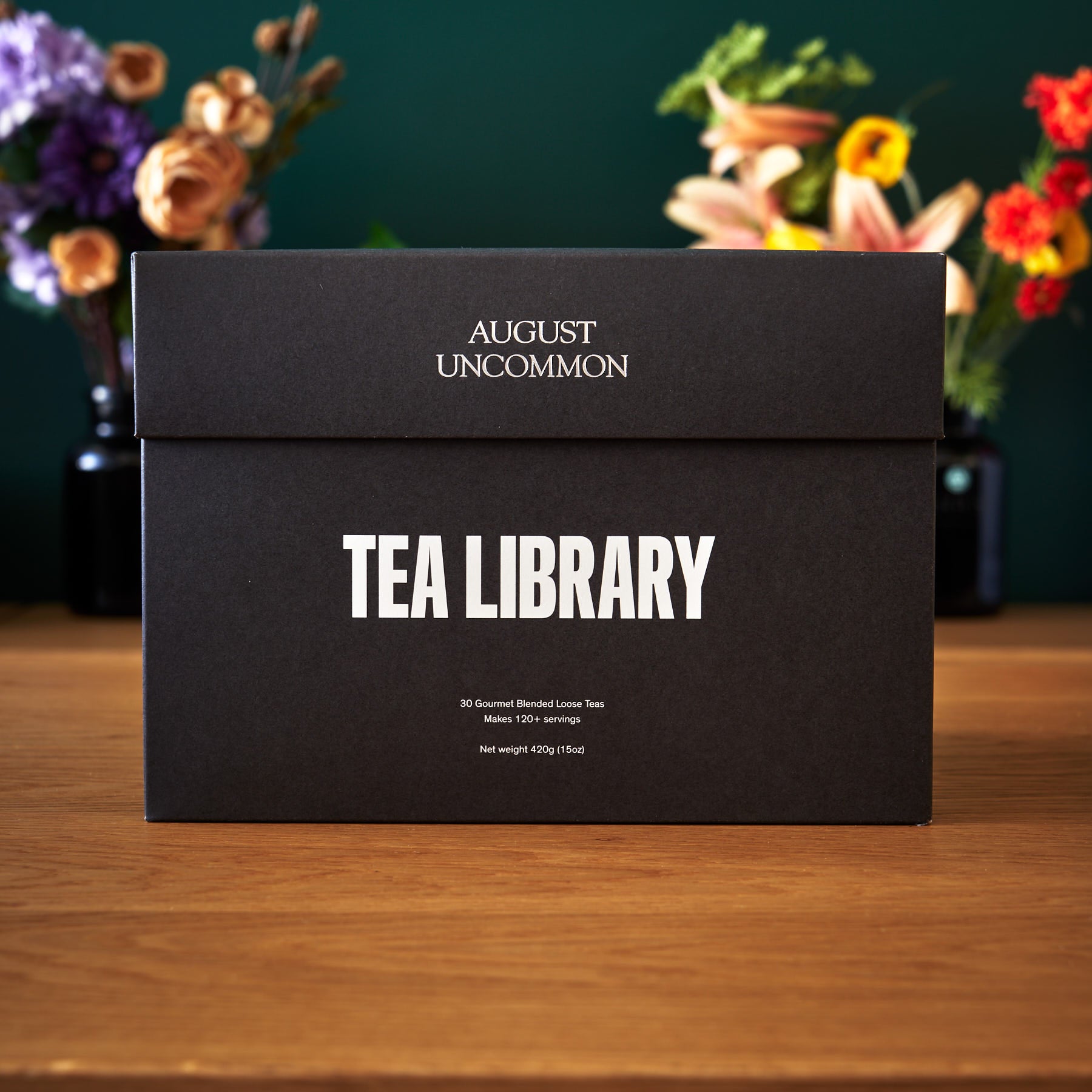August Uncommon Tea Deluxe 30 Tea Sampler box with assorted tea tins, showcasing a variety of tea flavors in an elegant collection.