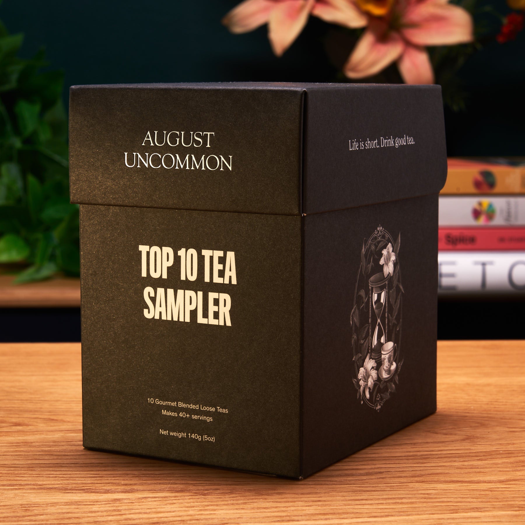 Assorted tea sampler box from August Uncommon Tea featuring ten trending teas, displayed with colorful tea packaging.