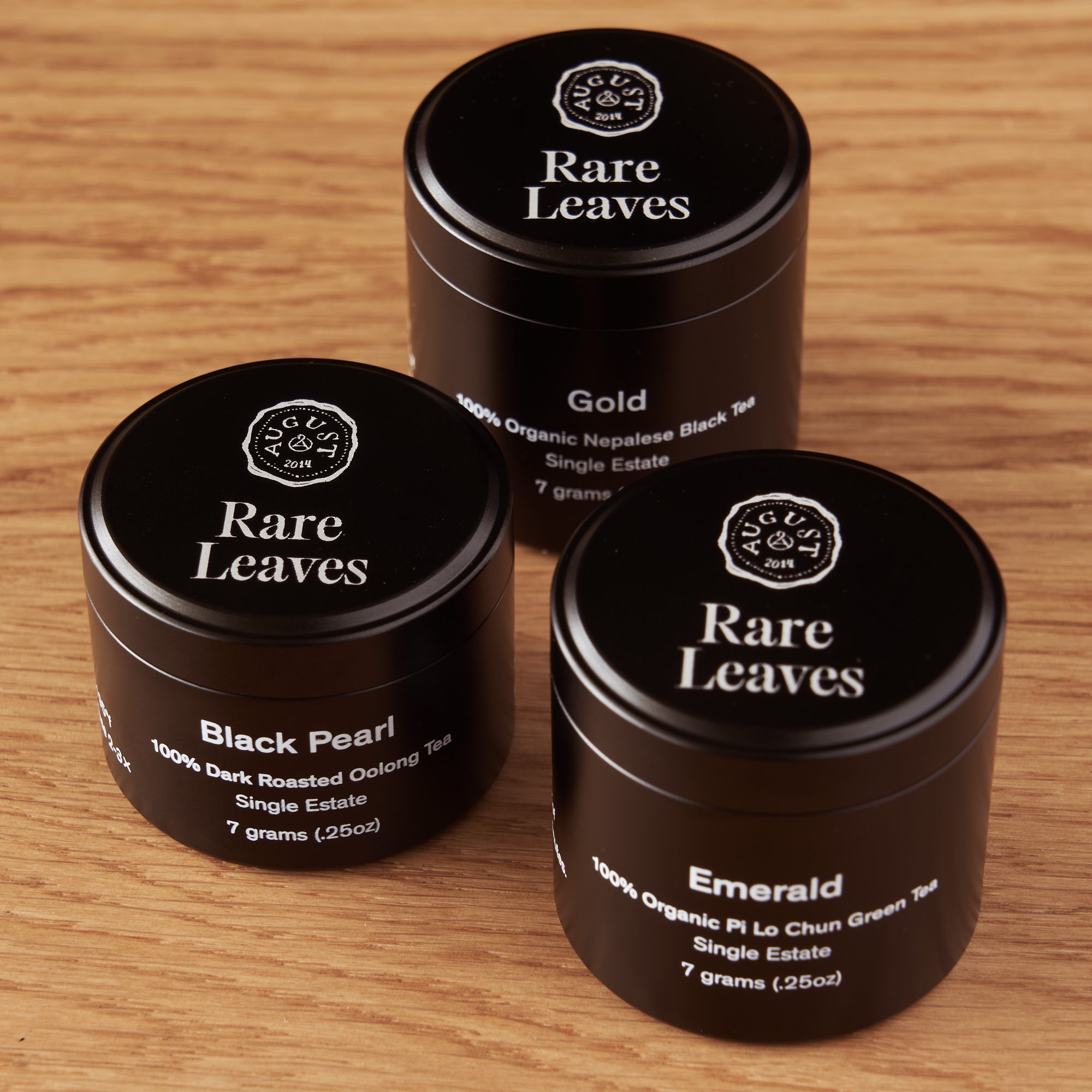 Mini tin of Rare Leaves Single Origin Tea sampler by August Uncommon Tea, showcasing a colorful tea packaging design.