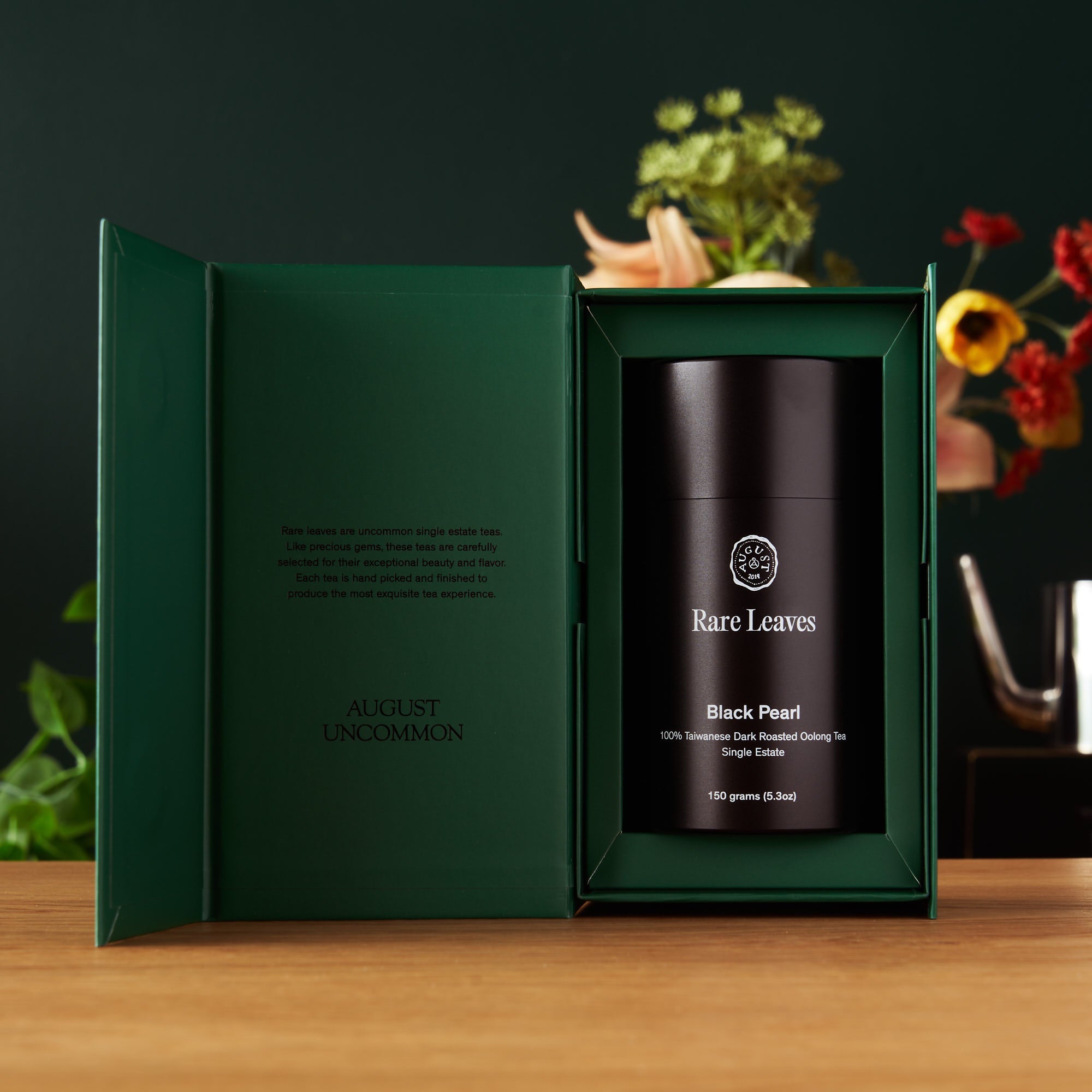 Luxury single origin tea gift set featuring a bundle of rare leaves from August Uncommon Tea, displayed with assorted tea tins and packaging.