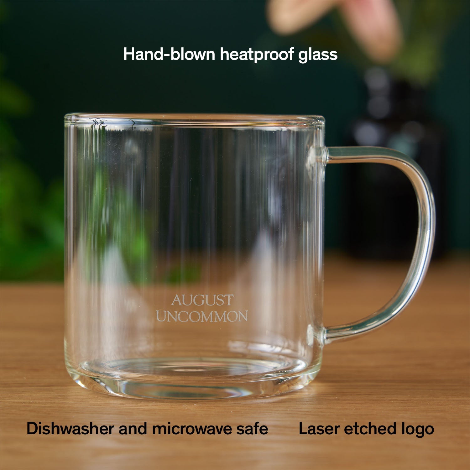 Clear glass mug from August Uncommon Tea, elegant teaware for hot beverages, showcasing a sleek, transparent design with a comfortable handle.