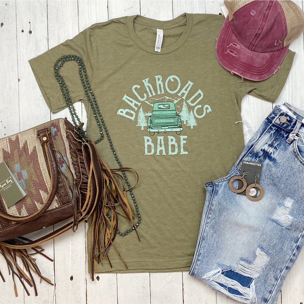 The Graphic Tee Backroads Babe SS Graphic Tee featuring a vintage-inspired design on soft cotton fabric.