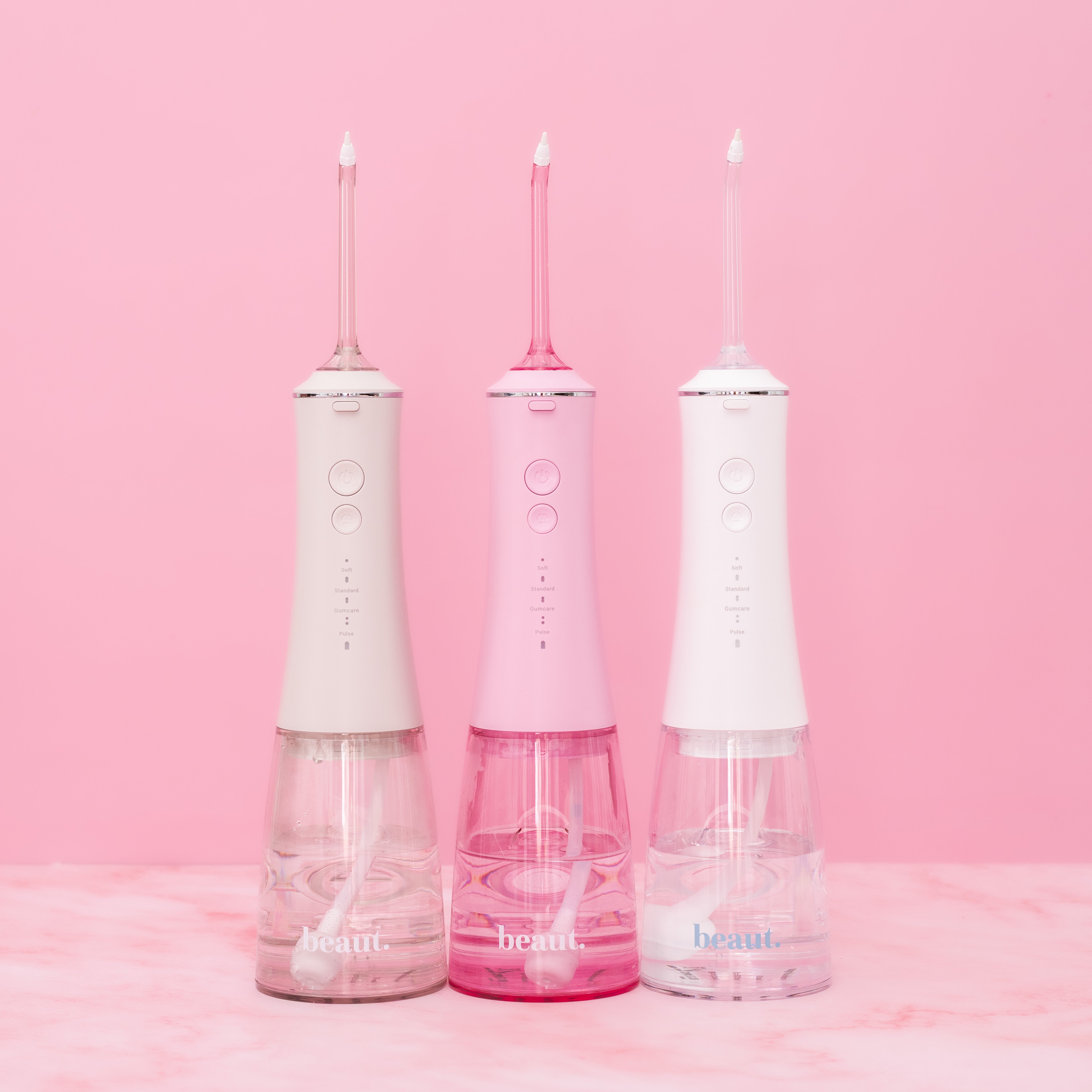 White H2O Hydroflossé dental water flosser by beaut.beautyco., with a sleek design and adjustable water pressure settings.
