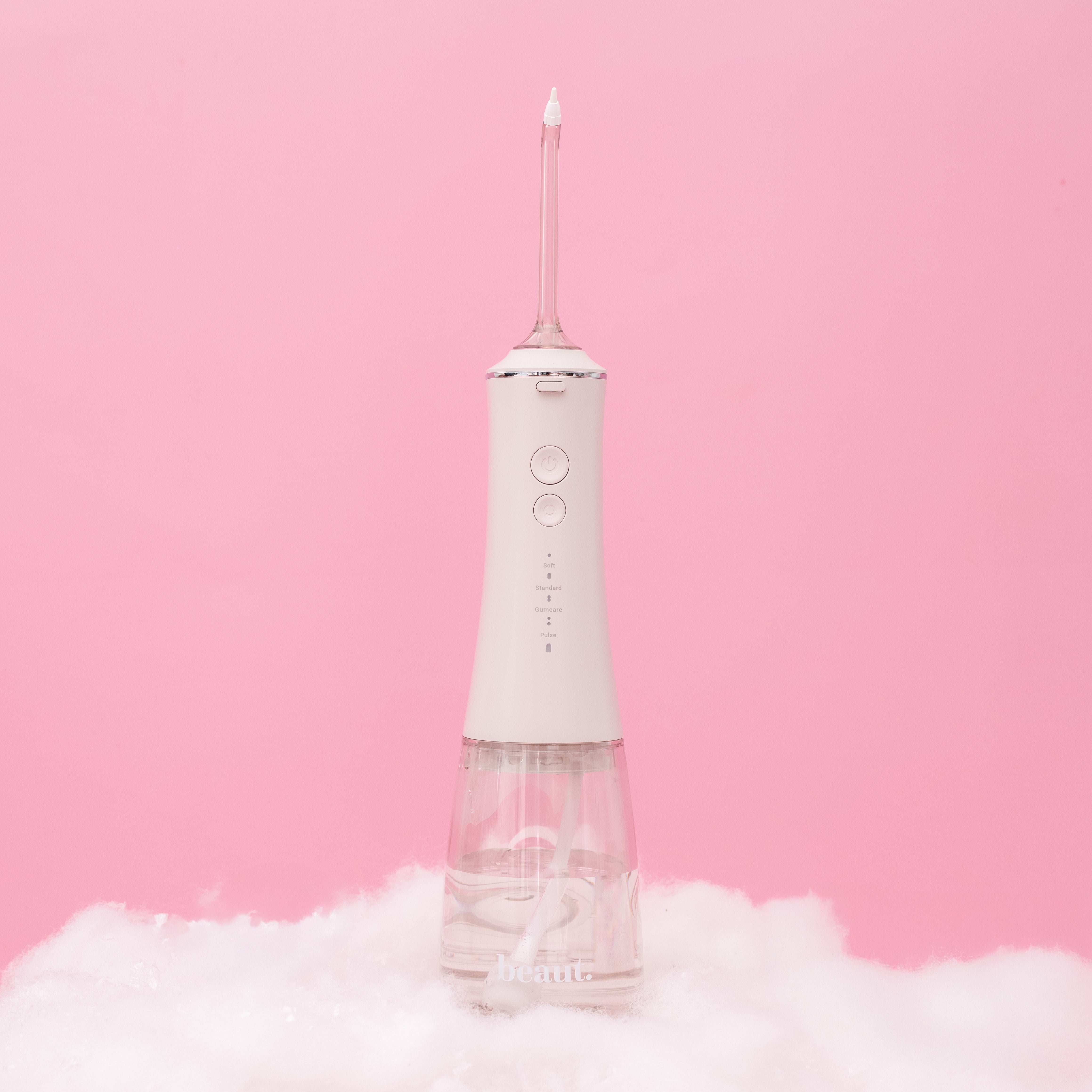 White H2O Hydroflossé water flosser by beaut.beautyco. with sleek design and water reservoir for oral hygiene.