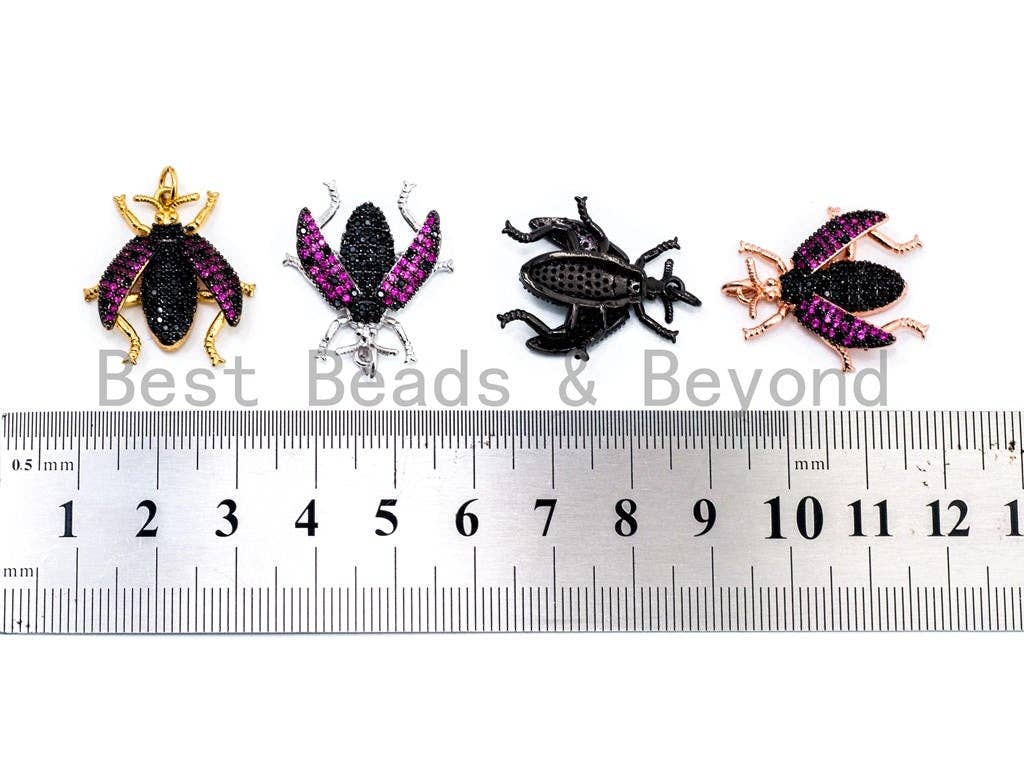 Black beetle-inspired charm pendant with fuchsia cubic zirconia accents, gold, rose gold, silver, and black finishes, 23x25mm.