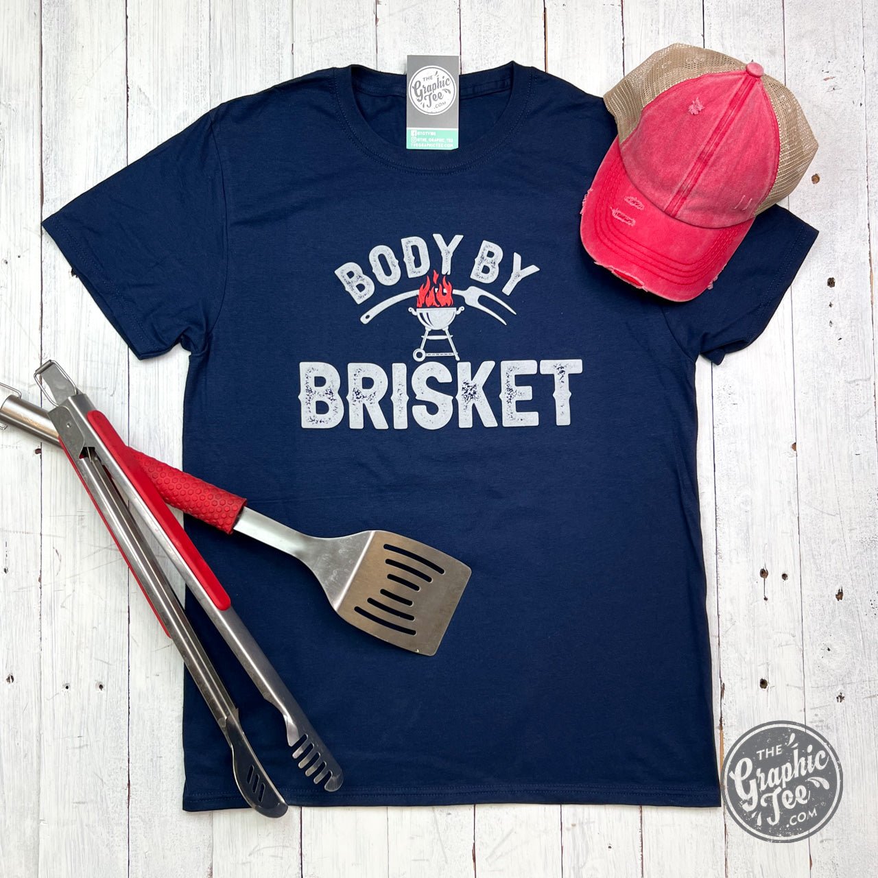 Adult SS Graphic Tee from The Graphic Tee featuring "Body By Brisket" design on soft cotton fabric.