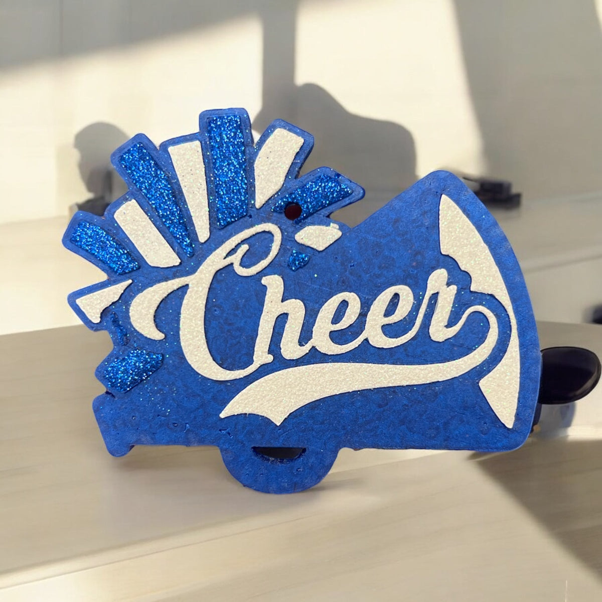 Blue Cheer Freshie air freshener by Bug & Bean Freshies hanging with cheerful design and vibrant blue color.
